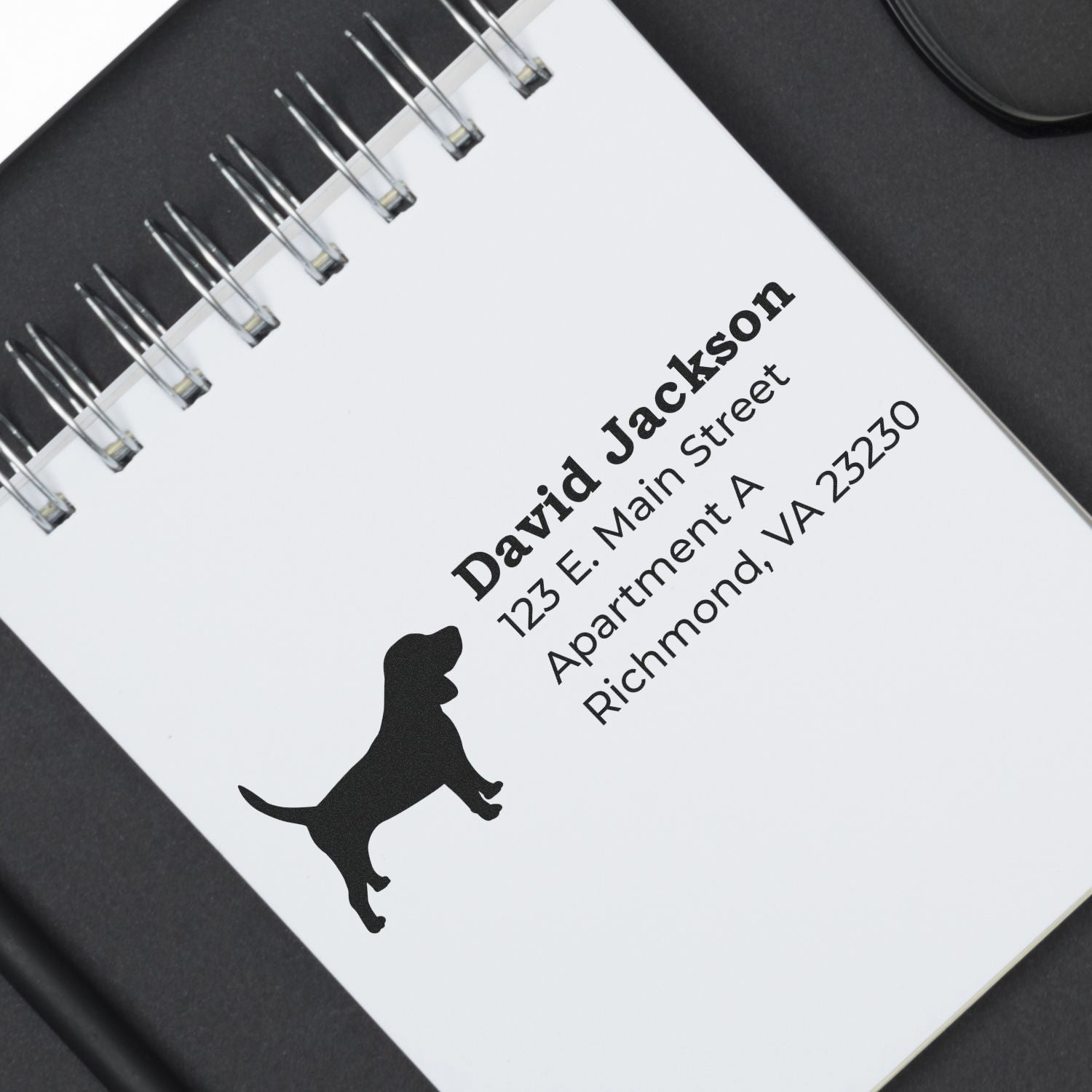 PSI Pre-Inked Personalized Beagle Address Stamp on a notepad, featuring a beagle silhouette and sample address text in black ink.