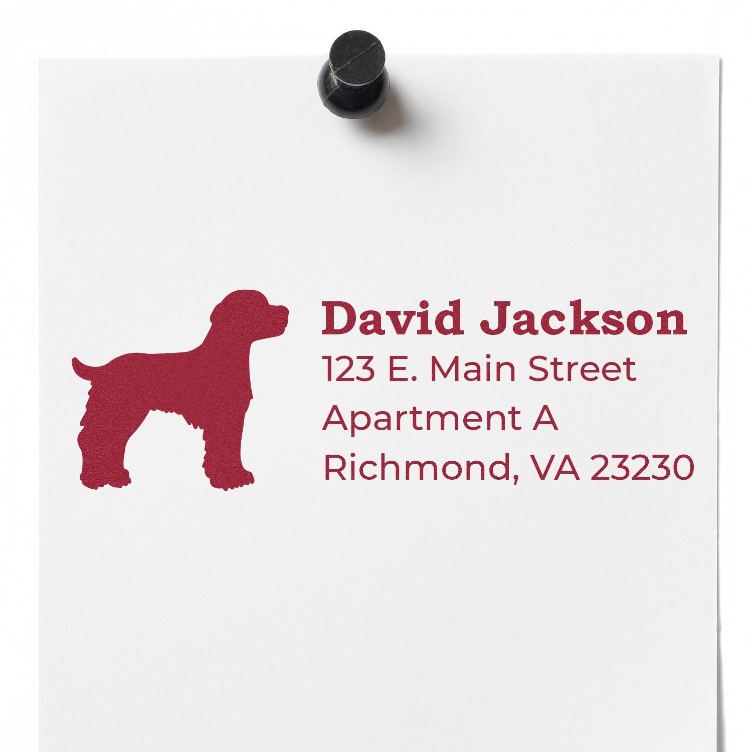 Self-Inking Brittany Spaniel Dog Address Stamp on white paper with red dog silhouette and sample address text. Magnet holds paper on a white background.