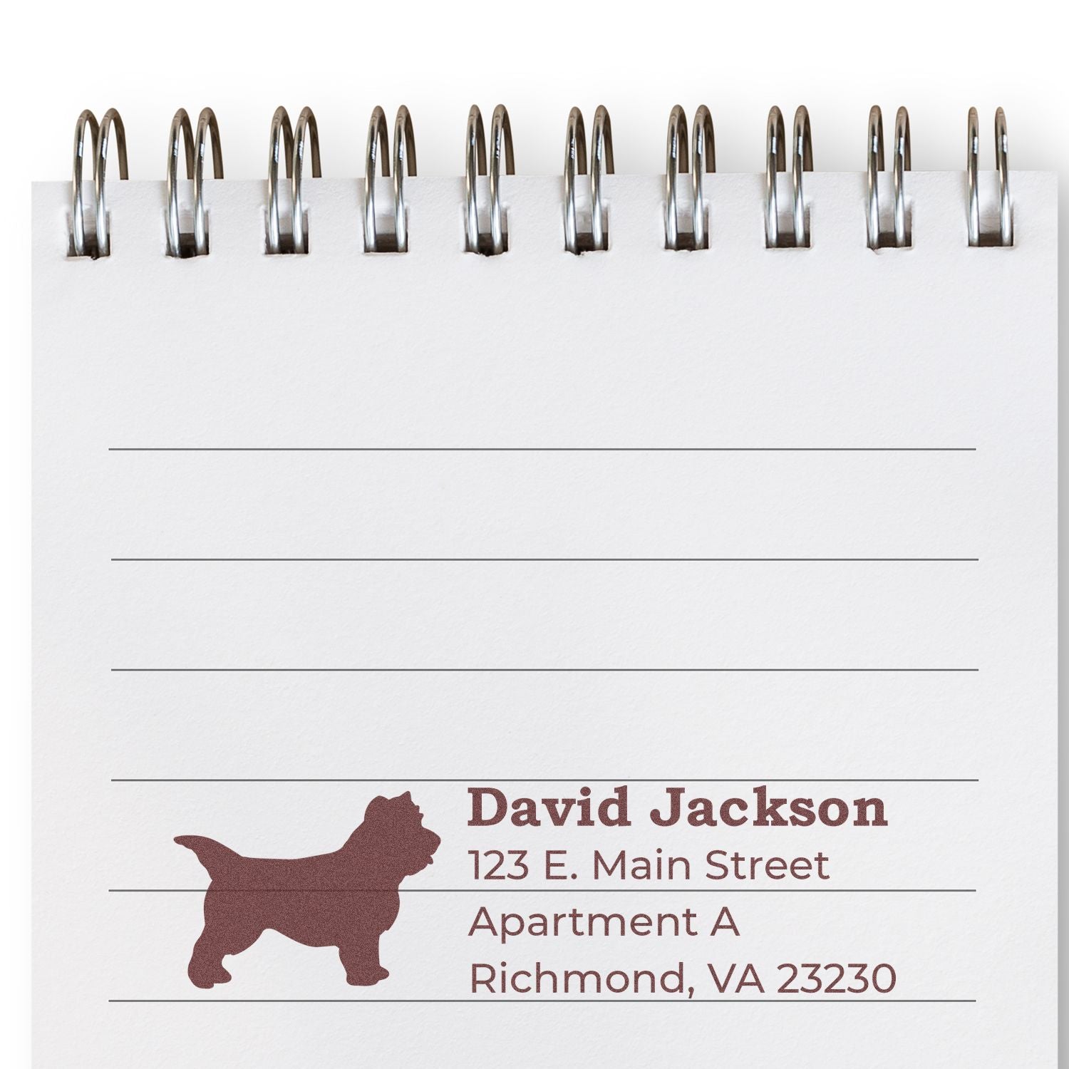 Slim Pre-Inked Cairn Terrier Address Stamp on a notepad, featuring a silhouette of a Cairn Terrier and sample address text in brown ink. Perfect for personalizing mail with style.