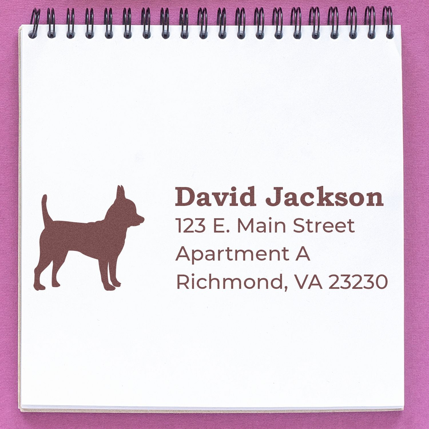 Self-Inking Chihuahua Dog Address Stamp on a notepad, featuring a silhouette of a Chihuahua and sample address text in brown ink. Perfect for personalizing mail with a cute dog design.