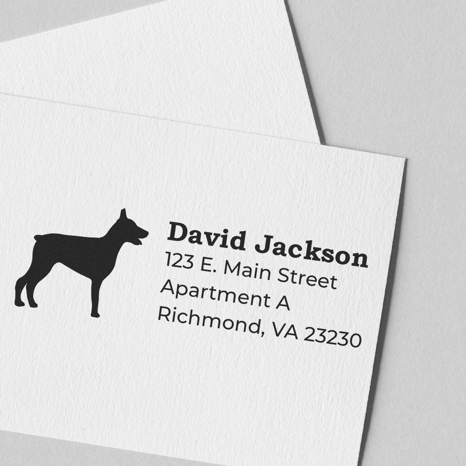 Slim Pre-Inked Doberman Address Stamp on white card with a silhouette of a Doberman and sample address text. Perfect for personalized stationery and efficient mailing.