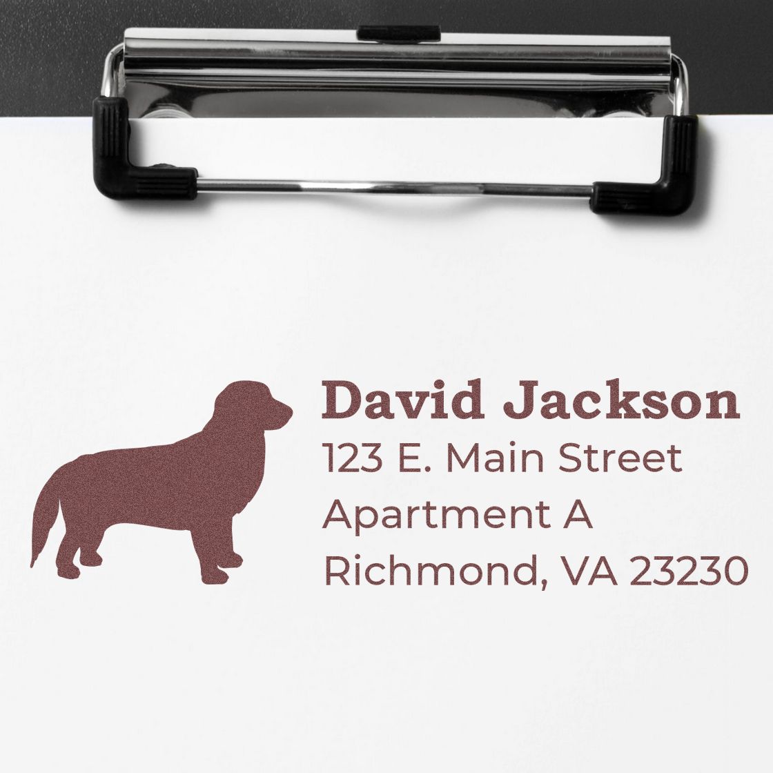 Slim Pre-Inked Golden Retriever Address Stamp on paper, featuring a silhouette of a golden retriever and sample address text in brown ink on a clipboard.