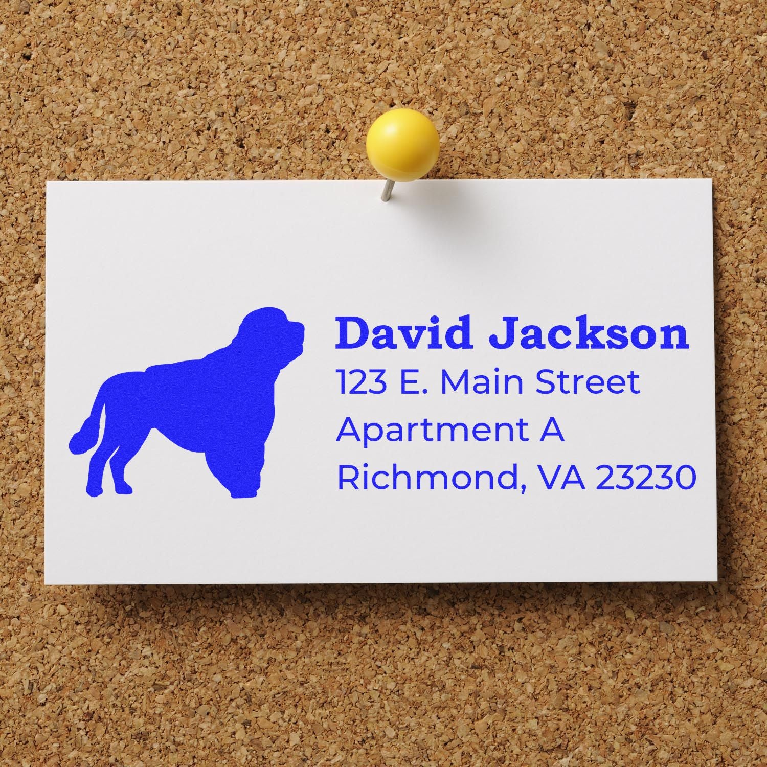 Portuguese Water Dog Silhouette Address Rubber Stamp on a card pinned to a corkboard, featuring a blue dog silhouette and sample address text in bold blue font.