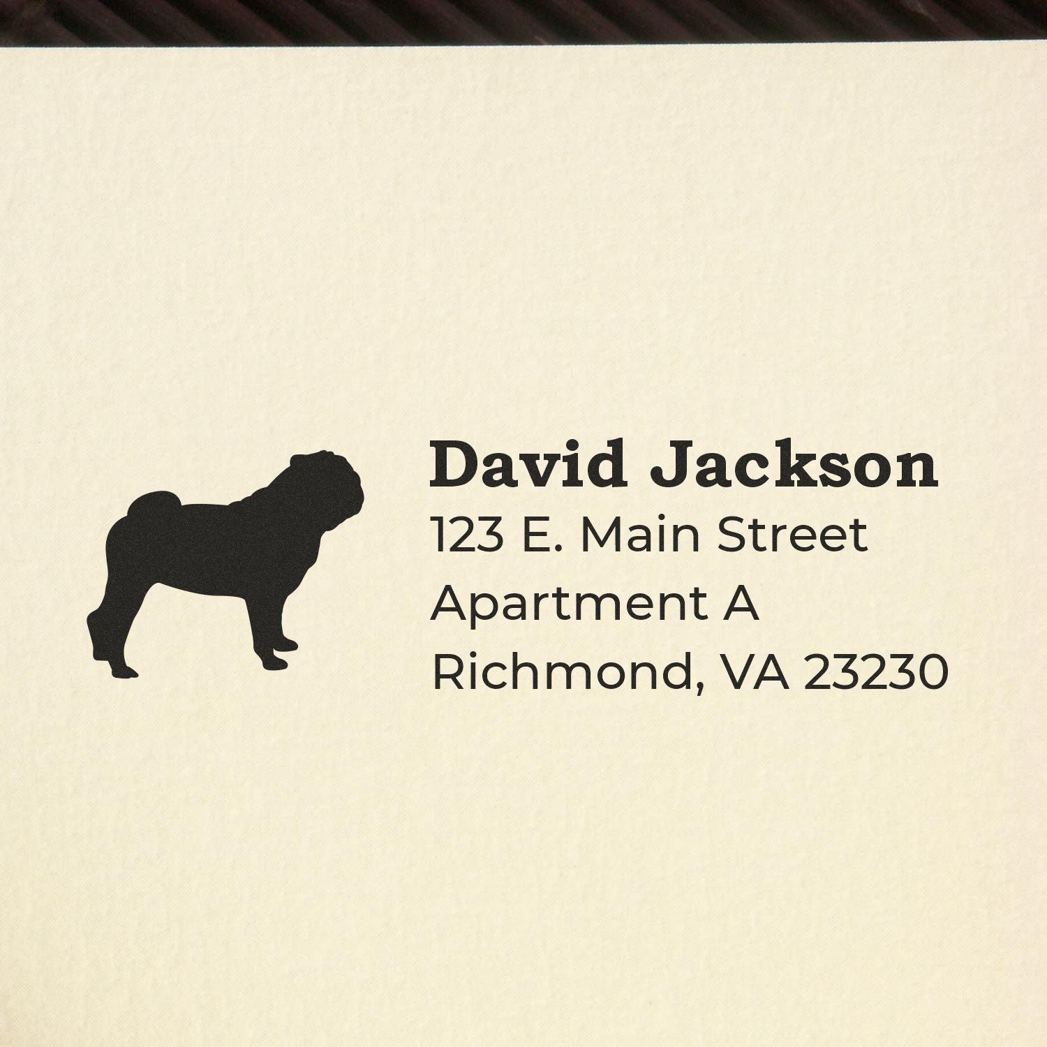 Slim Pre-Inked Pug Address Stamp on paper, featuring a pug silhouette and sample address text in bold, clear font. Perfect for personalizing mail with a touch of charm and efficiency.