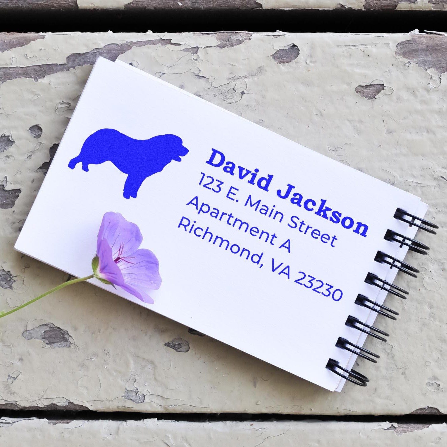 Pyrenean Mountain Dog Silhouette Address Rubber Stamp on a notepad with a purple flower, displaying a sample address in blue ink.