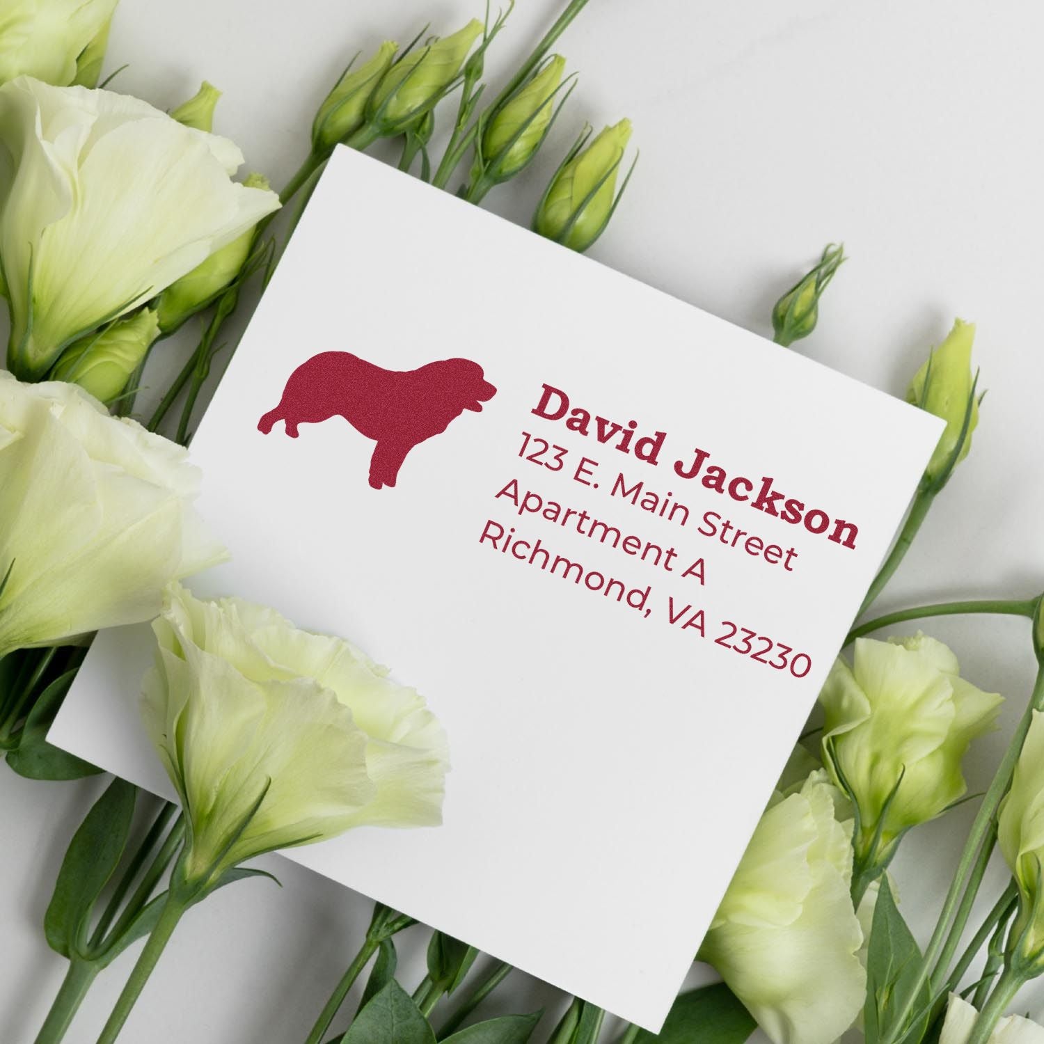 Pyrenean Mountain Dog Silhouette Address Rubber Stamp on a white card with red text, surrounded by white flowers. The stamp features a dog silhouette, adding a personal touch to the address.