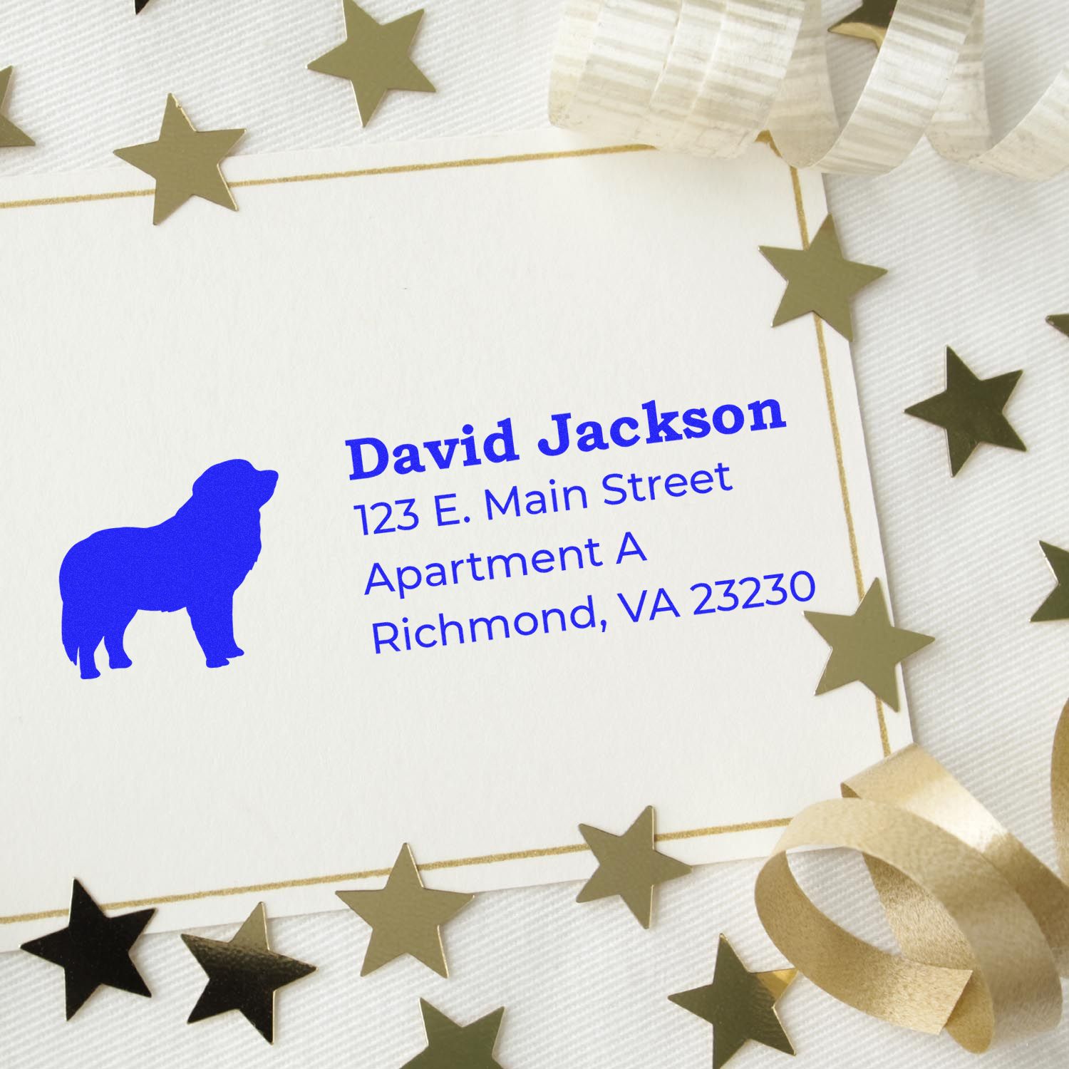 Self-Inking Pyrenees Dog Address Stamp on a card with gold stars and ribbon. Blue dog silhouette and address text on white paper. Perfect for personalized mailings.