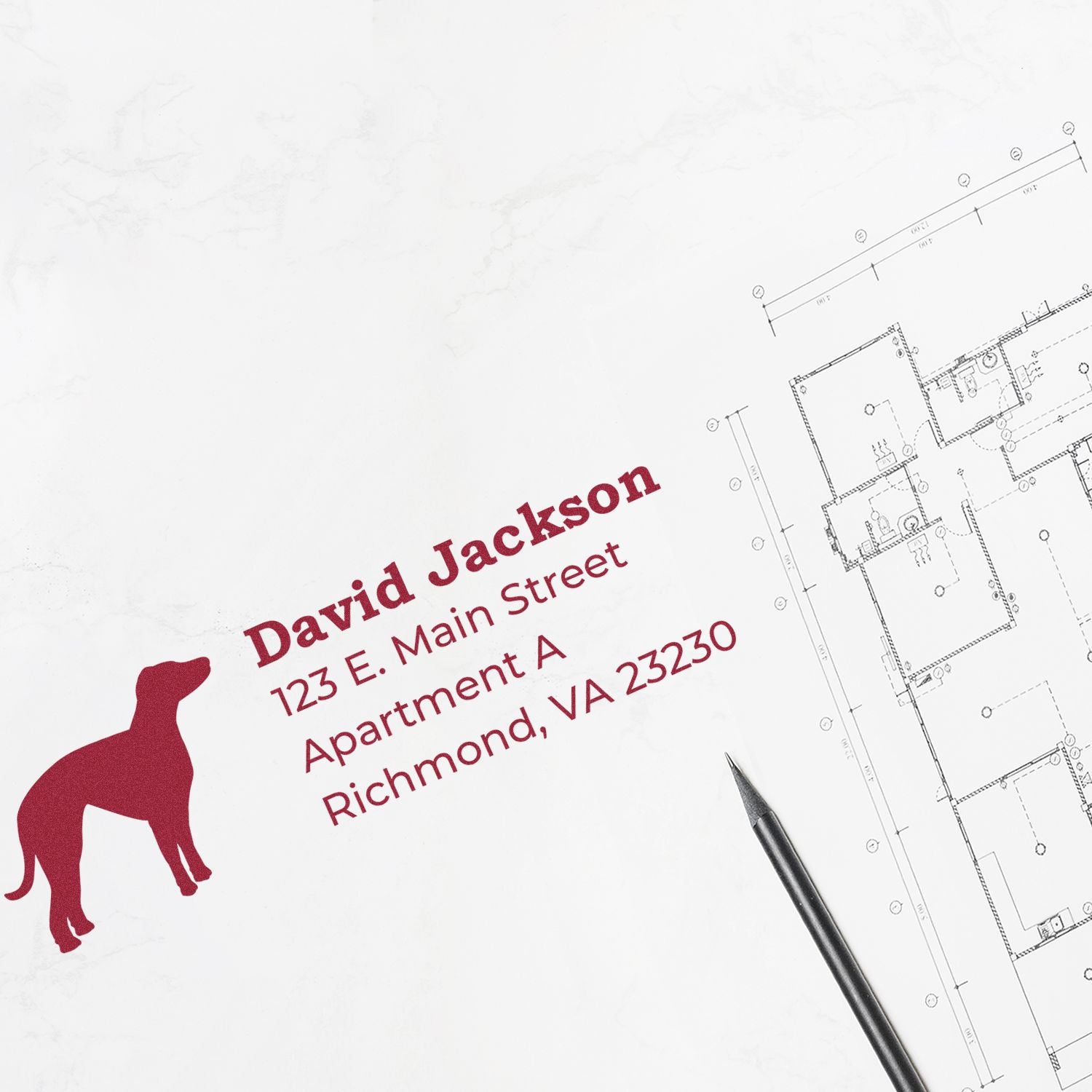 Whippet Silhouette Address Rubber Stamp on white paper next to architectural plans. Features a red whippet silhouette and sample address text in bold, elegant font. Pen placed nearby.