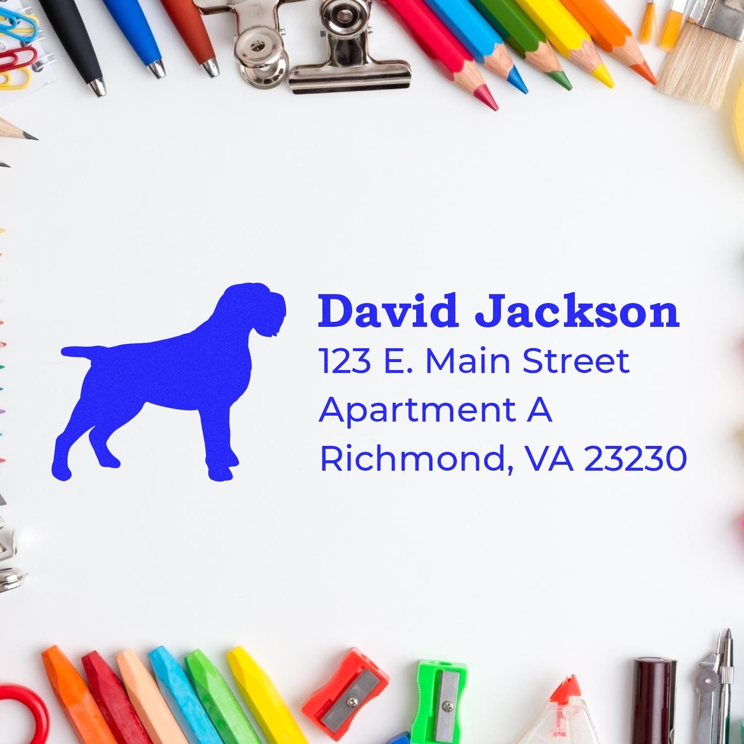 Self-Inking Wirehaired Pointing Griffon Dog Address Stamp on paper surrounded by colorful stationery, featuring a blue dog silhouette and sample address text.