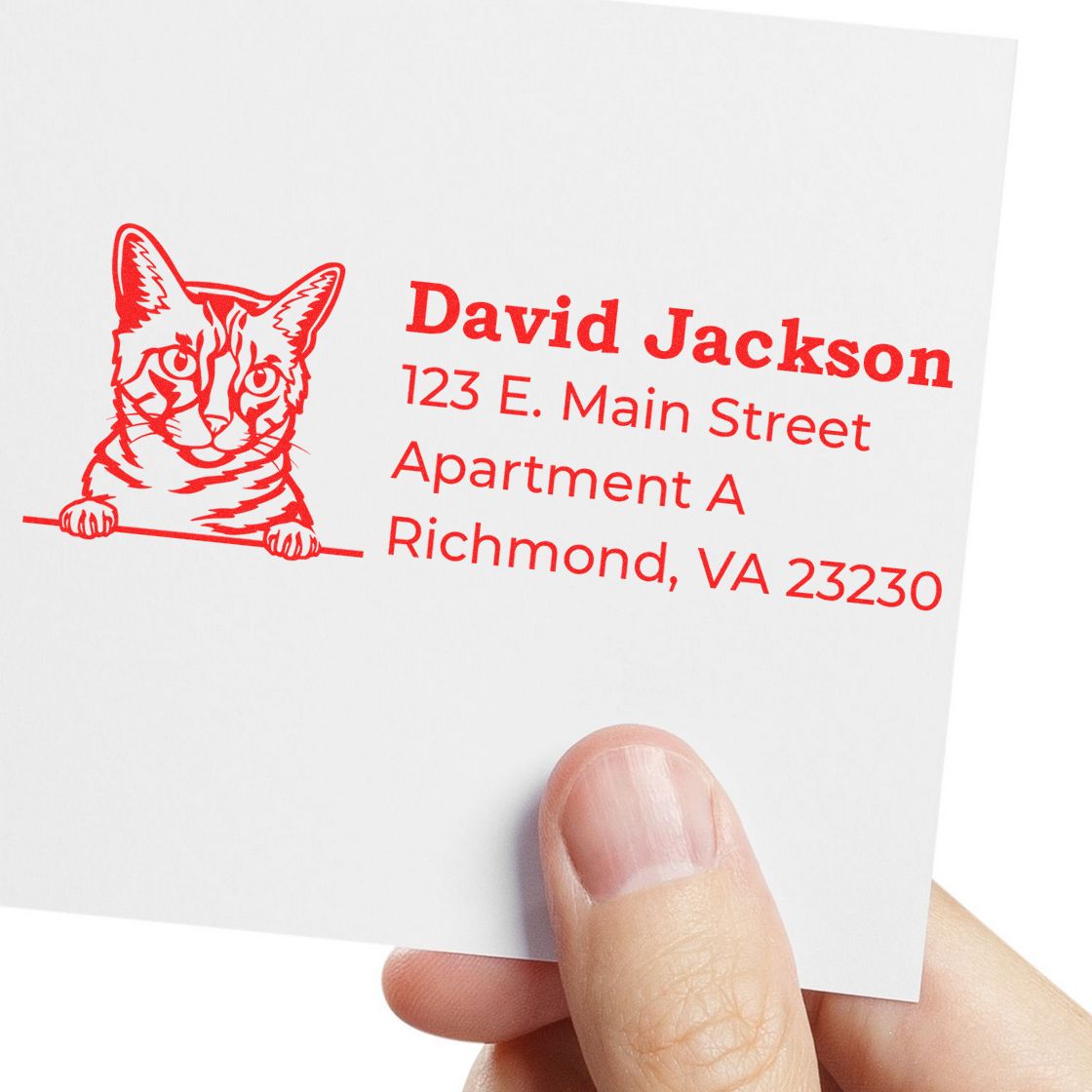 Wood Handle California Spangled Cat Address Stamp in use, featuring a red cat illustration and sample address on white paper, held by a hand. Perfect for personalized mail and stationery.