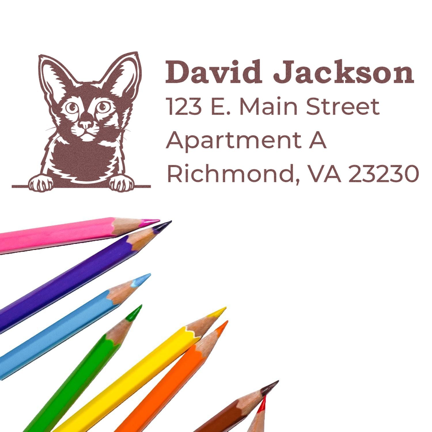 PSI Pre-Inked Peeking Javanese Cat Personalized Address Stamp on white paper with colorful pencils. Features a cat illustration and sample address text.