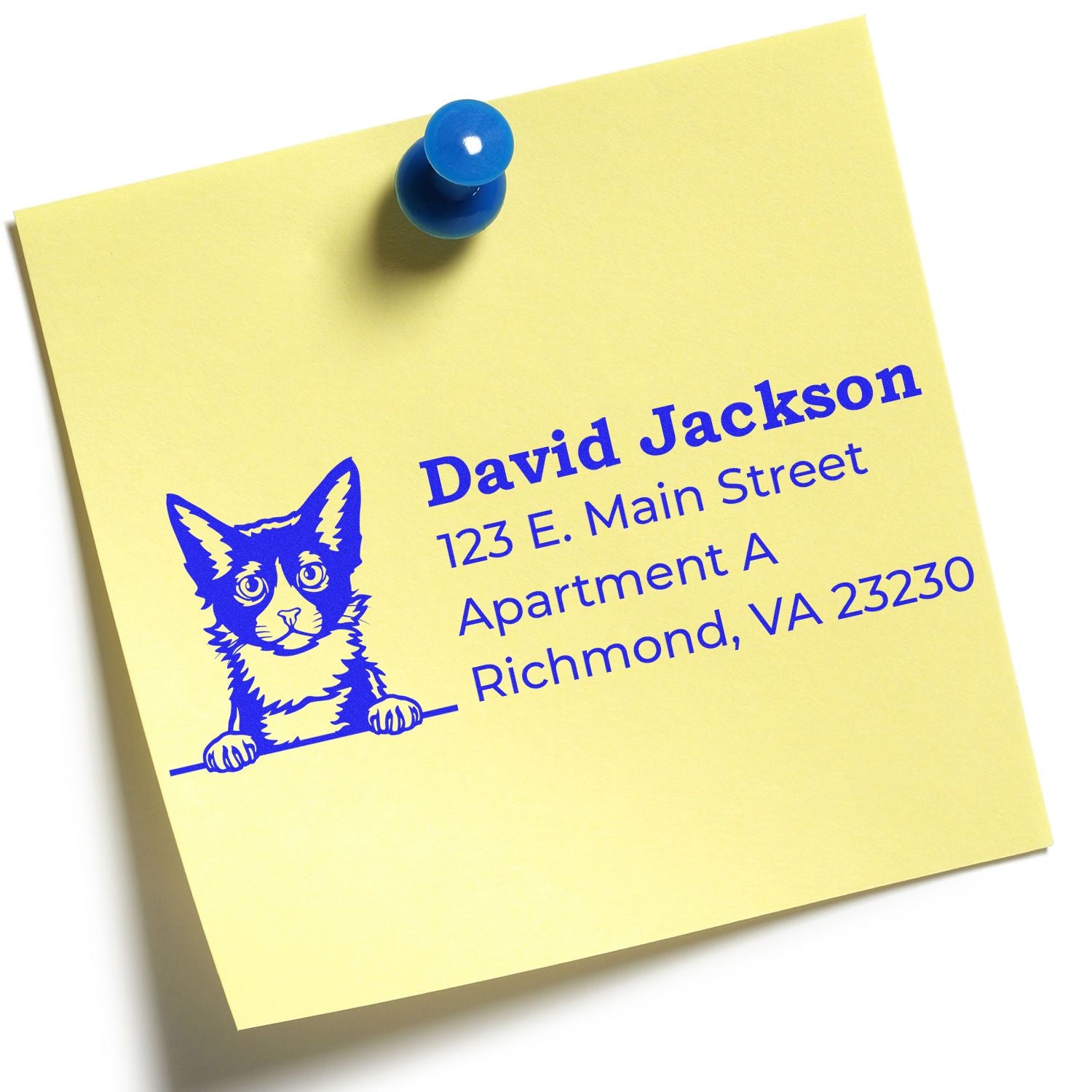 Yellow note with a blue pushpin featuring a stamped LaPerm cat illustration and address details. Showcases the Wood Handle LaPerm Cat Address Stamp in use.