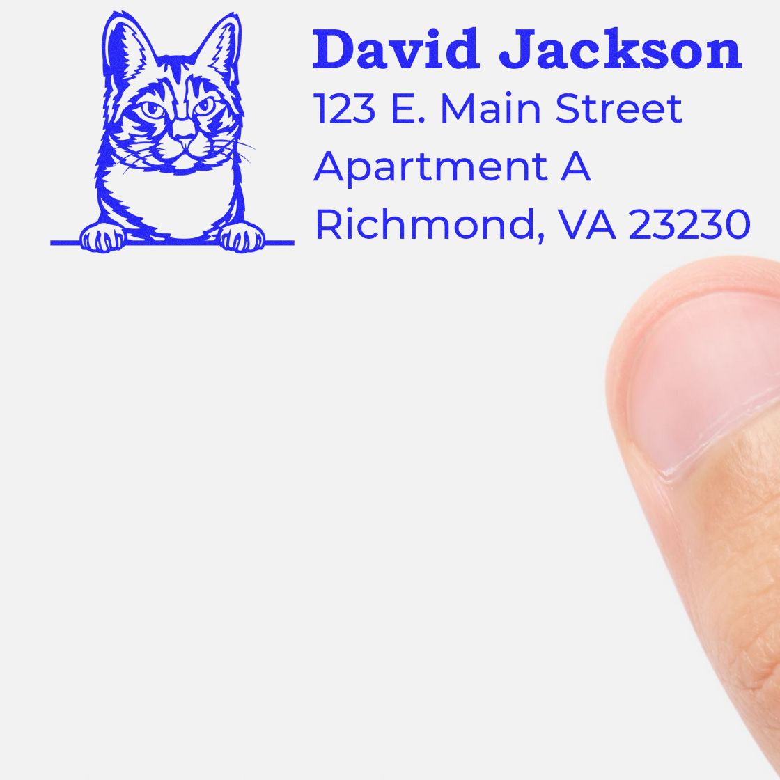 Wood Handle Manx Cat Address Stamp imprint showing a cat illustration with sample address details on white paper, next to a thumb for scale.