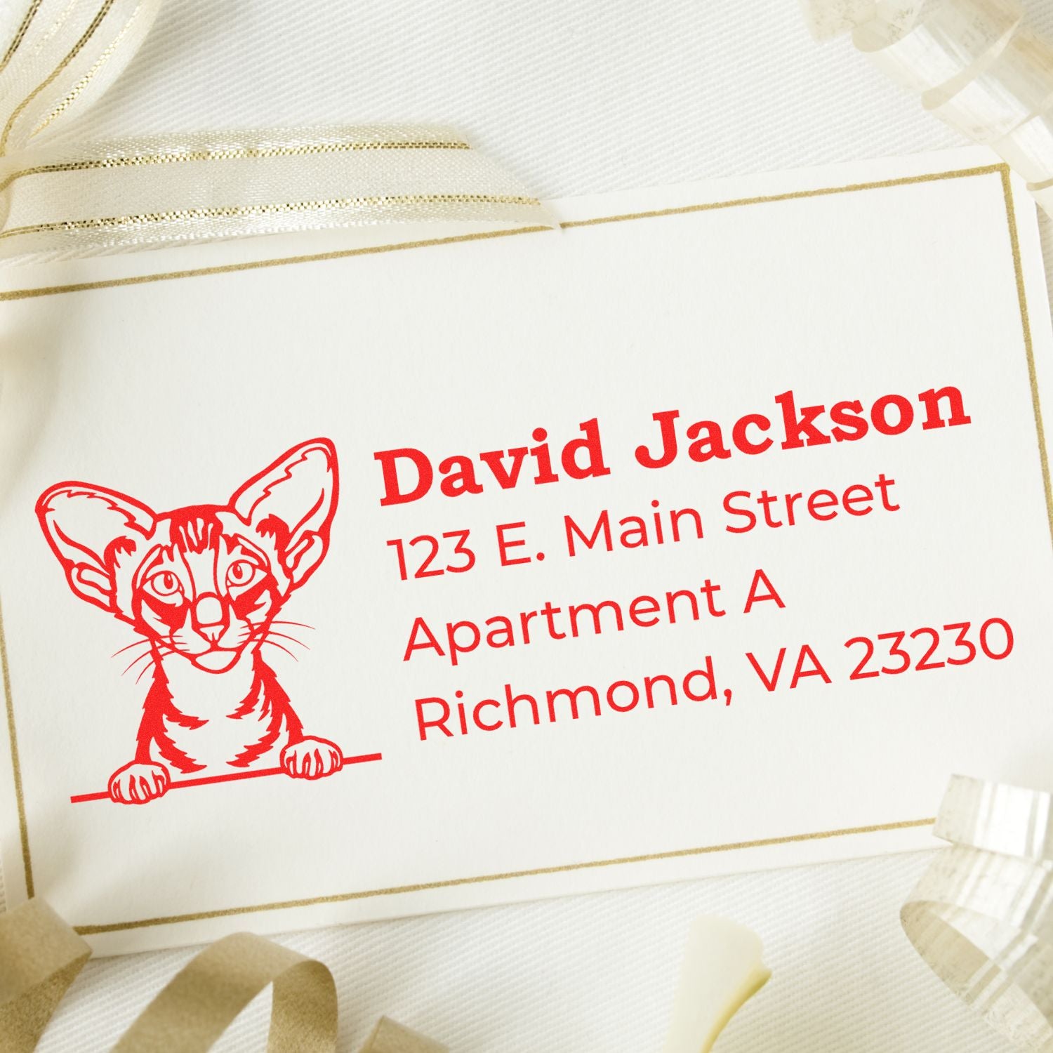 Wood Handle Oriental Shorthair Cat Address Stamp on a card with a red cat illustration and sample address. Surrounded by decorative ribbons, showcasing elegant and personalized stationery.