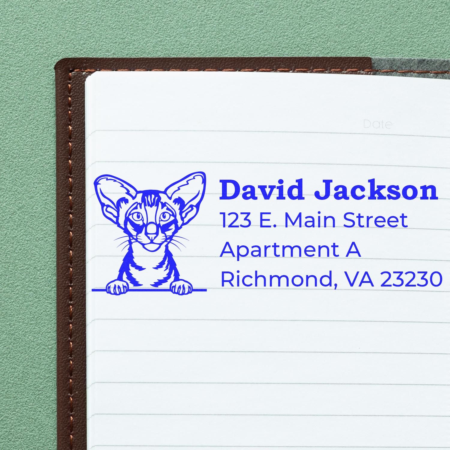 Wood Handle Oriental Shorthair Cat Address Stamp on a notebook, featuring a blue cat illustration and sample address text. Perfect for personalizing mail with a unique feline touch.