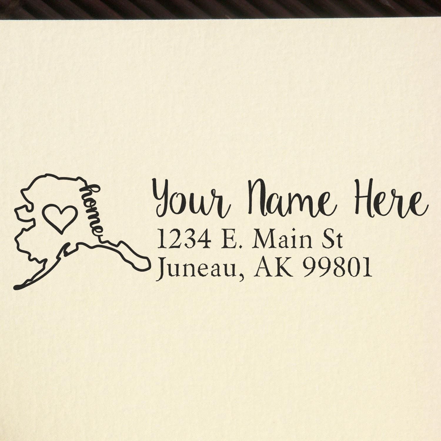 PSI Pre-Inked Personalized Alaska State Love Address Stamp on paper, featuring a heart within the Alaska outline and customizable address text in elegant font.