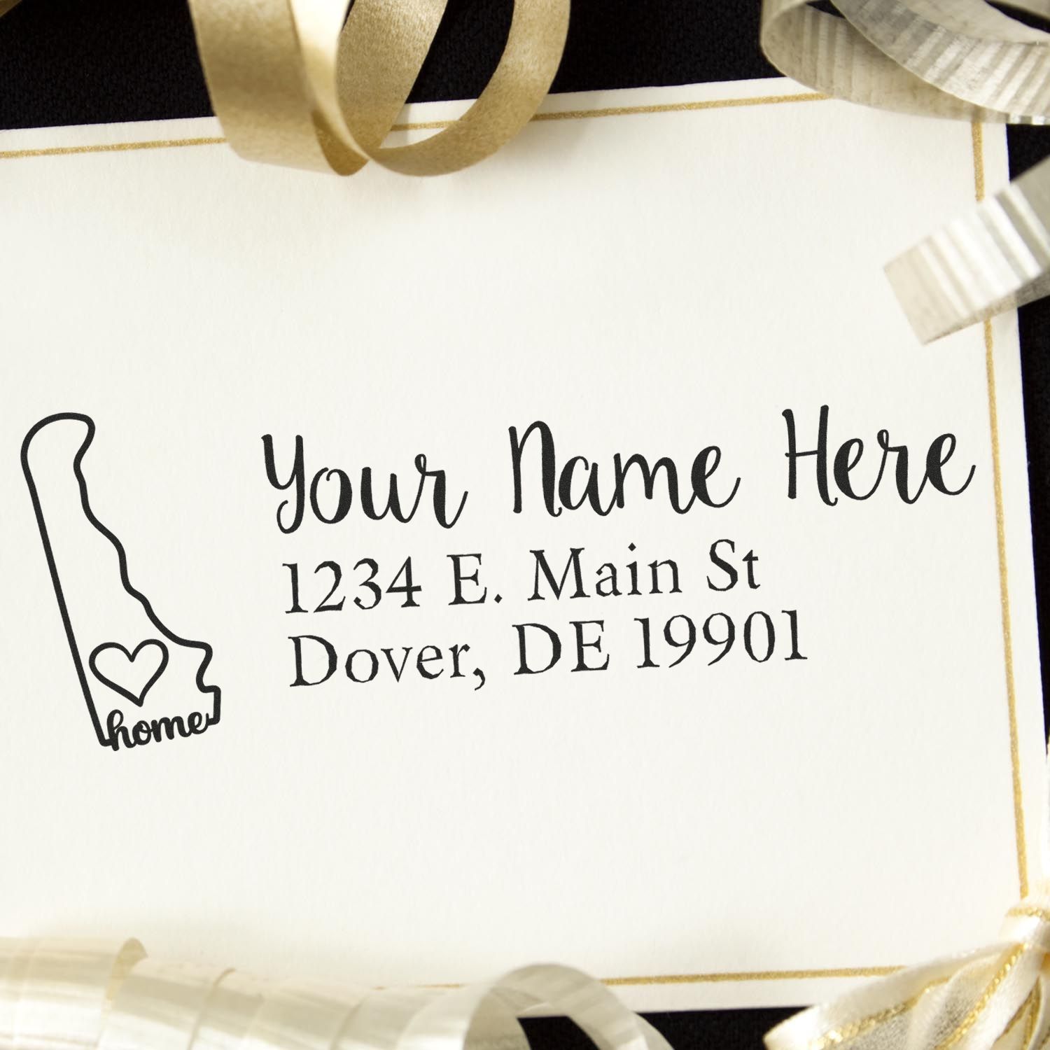 PSI Pre-Inked Personalized Delaware State Love Address Stamp on a card with gold and silver ribbons, featuring a Delaware outline and home heart design, customizable with name and address.