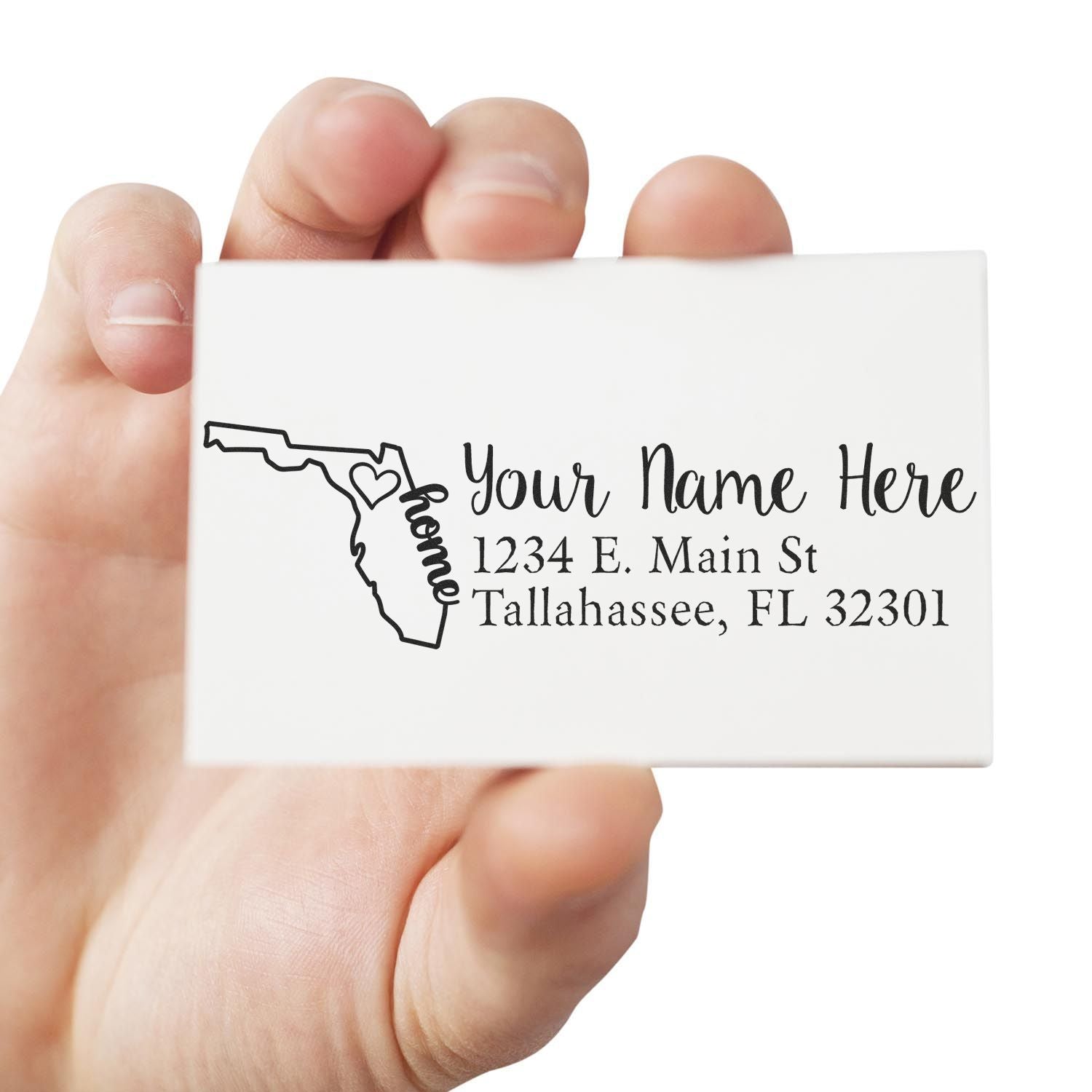 Hand holding a PSI Pre-Inked Personalized Florida State Love Address Stamp, featuring a Florida outline with a heart and customizable address text.