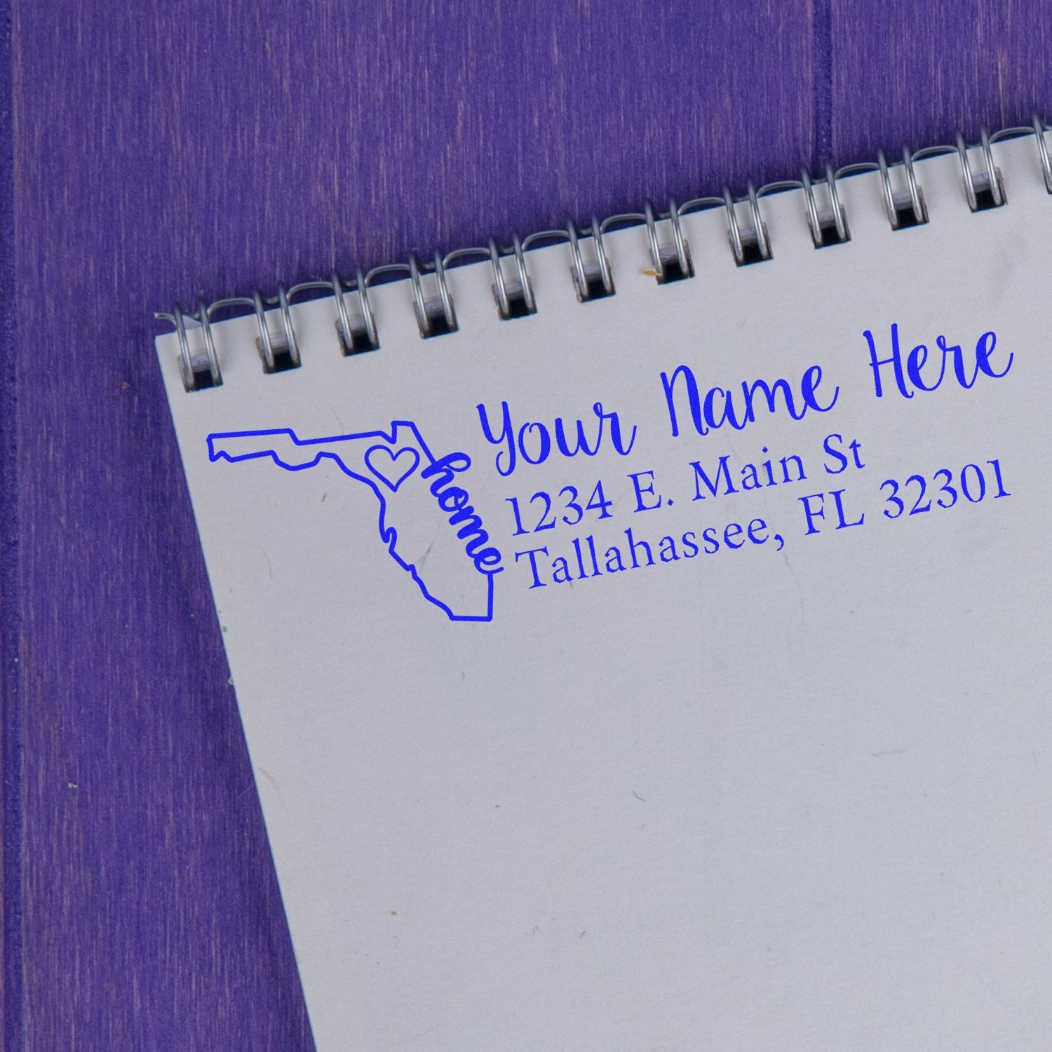 Florida Self-Inking State Love Address Stamp on a notepad, featuring a blue outline of Florida with home text and customizable address details. Perfect for personalizing mail with a touch of state pride.