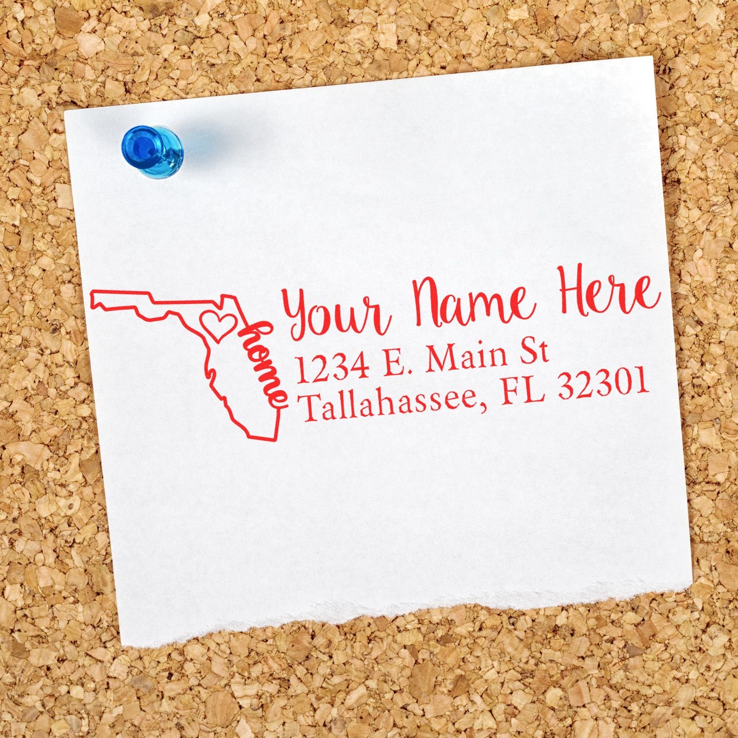 Slim Pre-Inked Florida State Love Custom Address Stamp on a corkboard, featuring a red outline of Florida with a heart and the word home, alongside customizable address text.