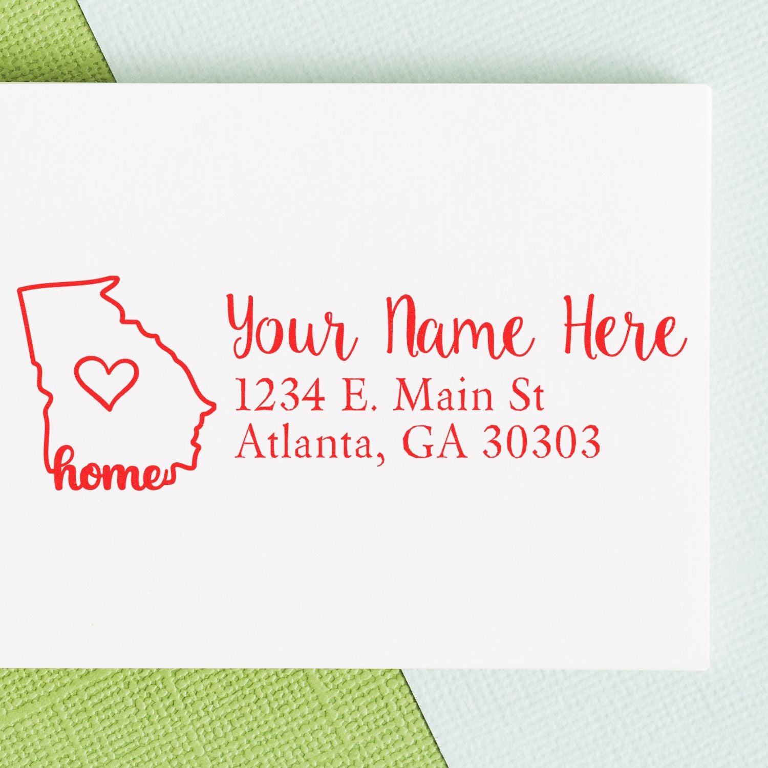 Georgia Self-Inking State Love Address Stamp on white paper with red ink, featuring a heart inside the state outline and customizable address text.