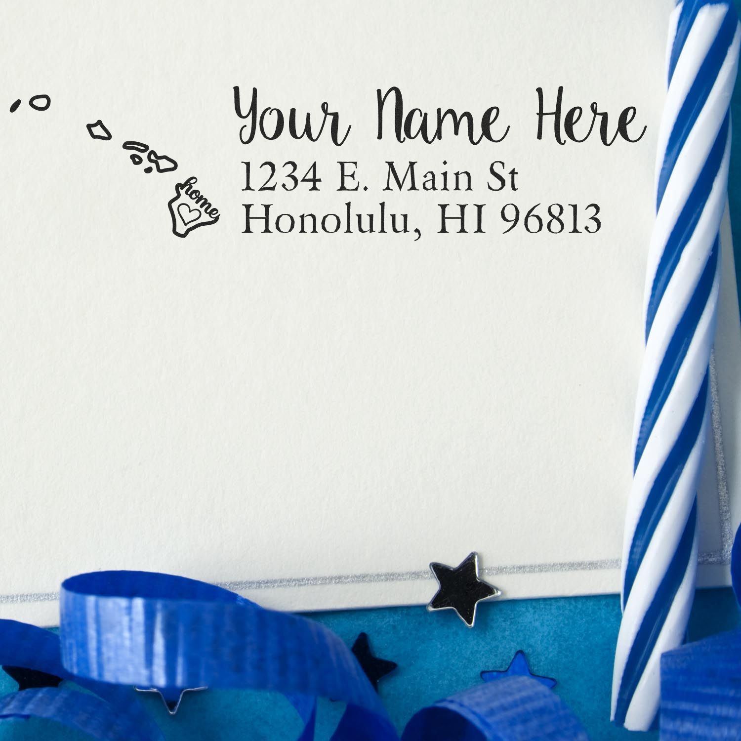 Hawaii Self-Inking State Love Address Stamp on an envelope with blue ribbon and stars, featuring a heart design and sample address in Honolulu, HI.