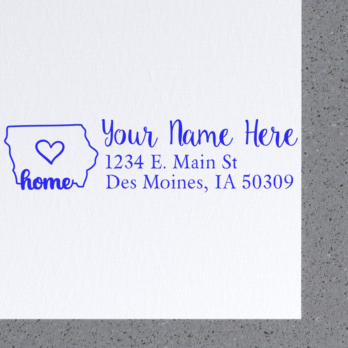 Iowa Self-Inking State Love Address Stamp on white paper, featuring a heart inside the state outline with home text, and customizable address lines in blue ink.