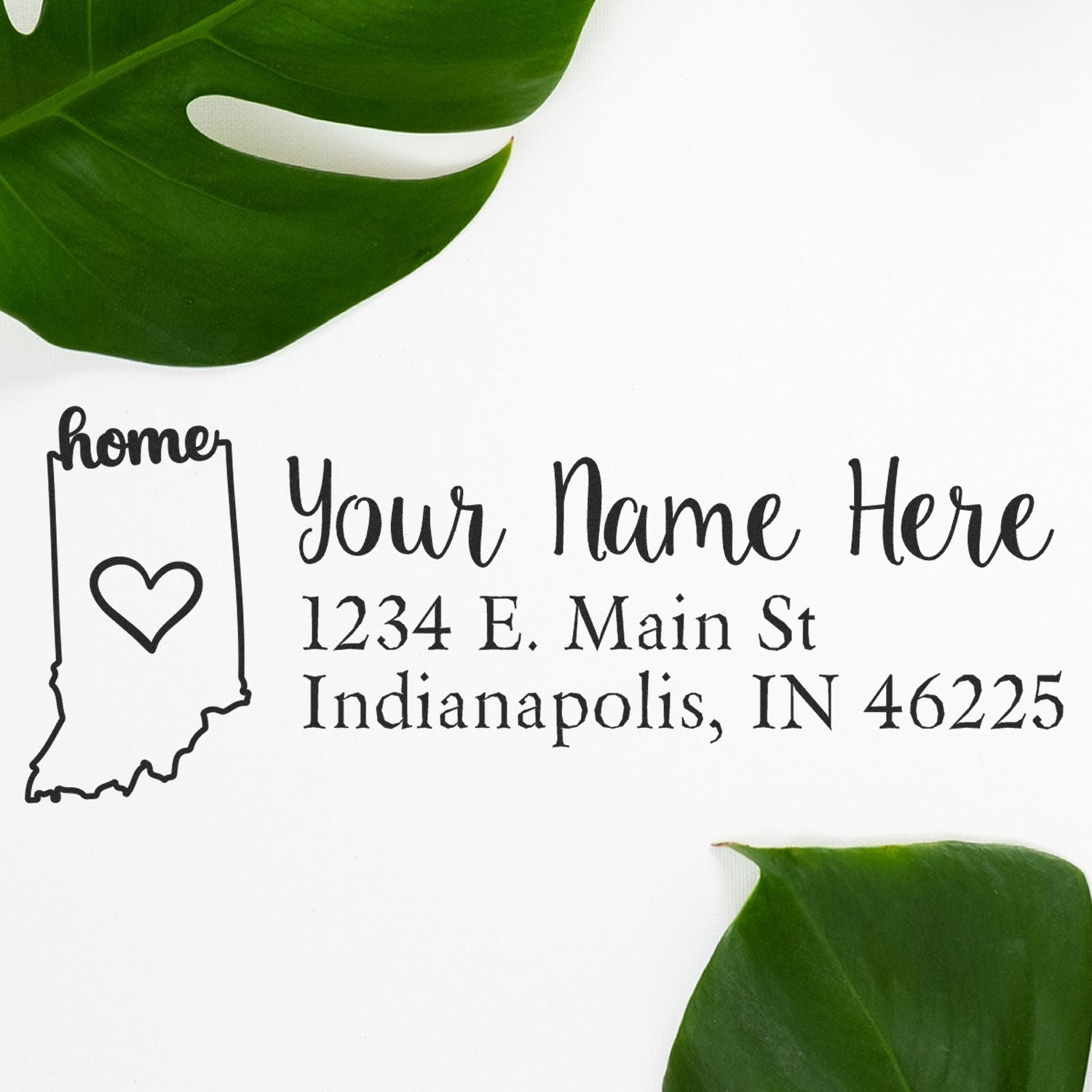 Wood Handle Indiana Custom Address Rubber Stamp on white paper with a heart design inside the state outline, surrounded by green leaves. Text reads Your Name Here, 1234 E. Main St, Indianapolis, IN 46225.