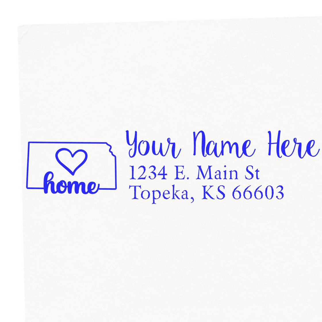 Slim Pre-Inked Kansas State Love Custom Address Stamp on white paper, featuring a heart inside the Kansas state outline with home text, and customizable address fields in blue ink.