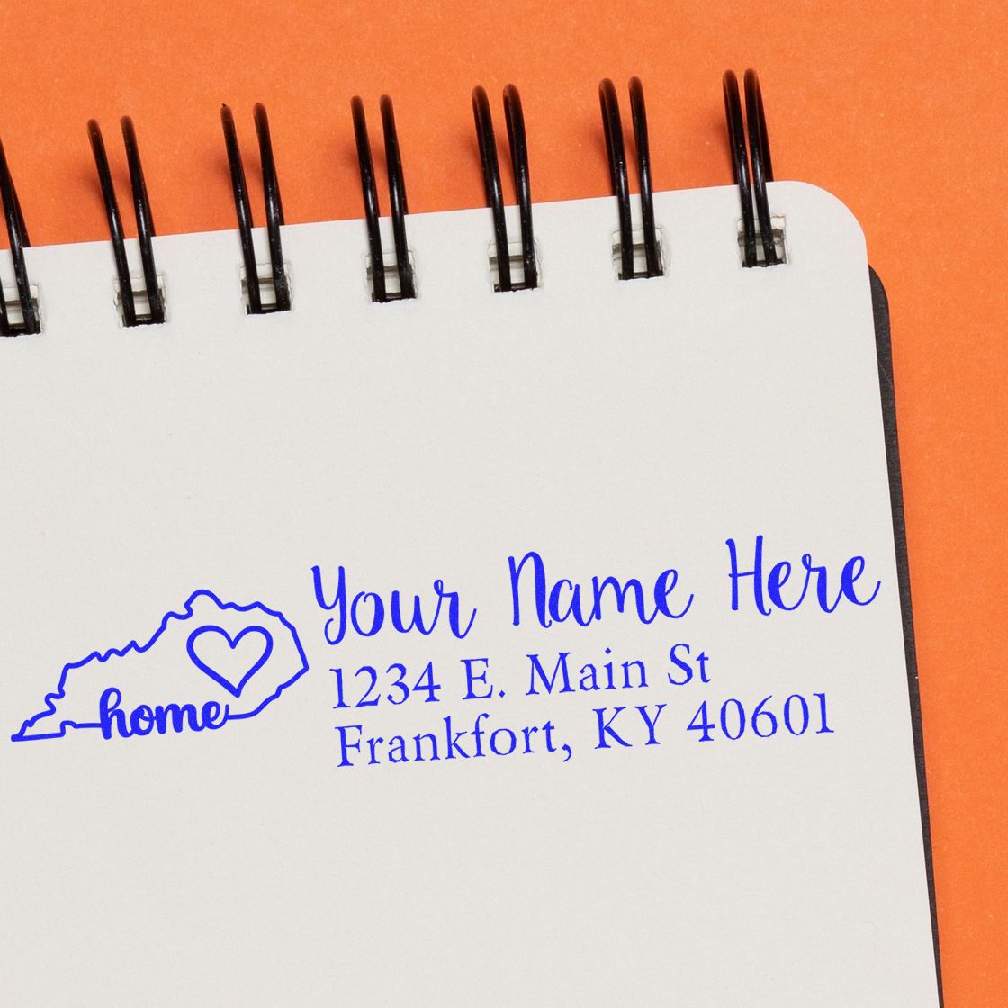 PSI Pre-Inked Personalized Kentucky State Love Address Stamp on a notepad, featuring a blue outline of Kentucky with a heart and the word home, alongside customizable address text.