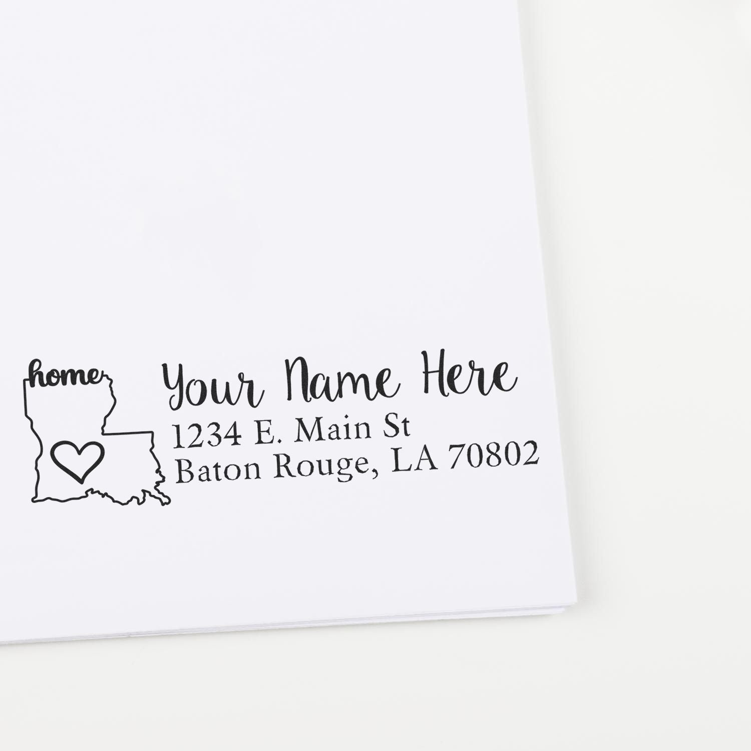 Wood Handle Louisiana Custom Address Rubber Stamp imprint on white paper, featuring a heart inside the state outline and customizable text for name and address in Baton Rouge, LA.