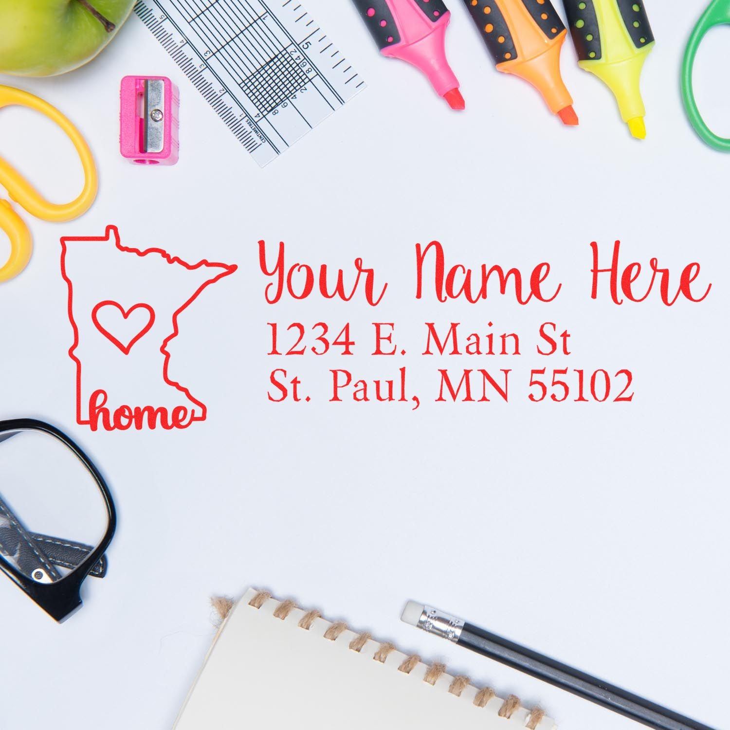 Wood Handle Minnesota Custom Address Rubber Stamp on a desk with colorful stationery, featuring a red state outline and sample address text. Perfect for personalized mail and stationery.