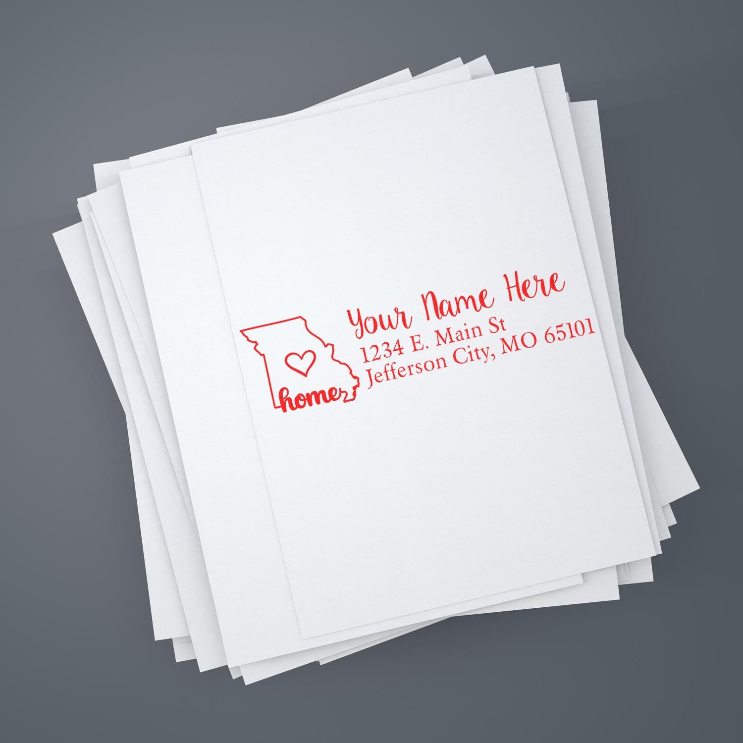 Slim Pre-Inked Missouri State Love Custom Address Stamp on white paper, featuring a red outline of Missouri with a heart and customizable address text.