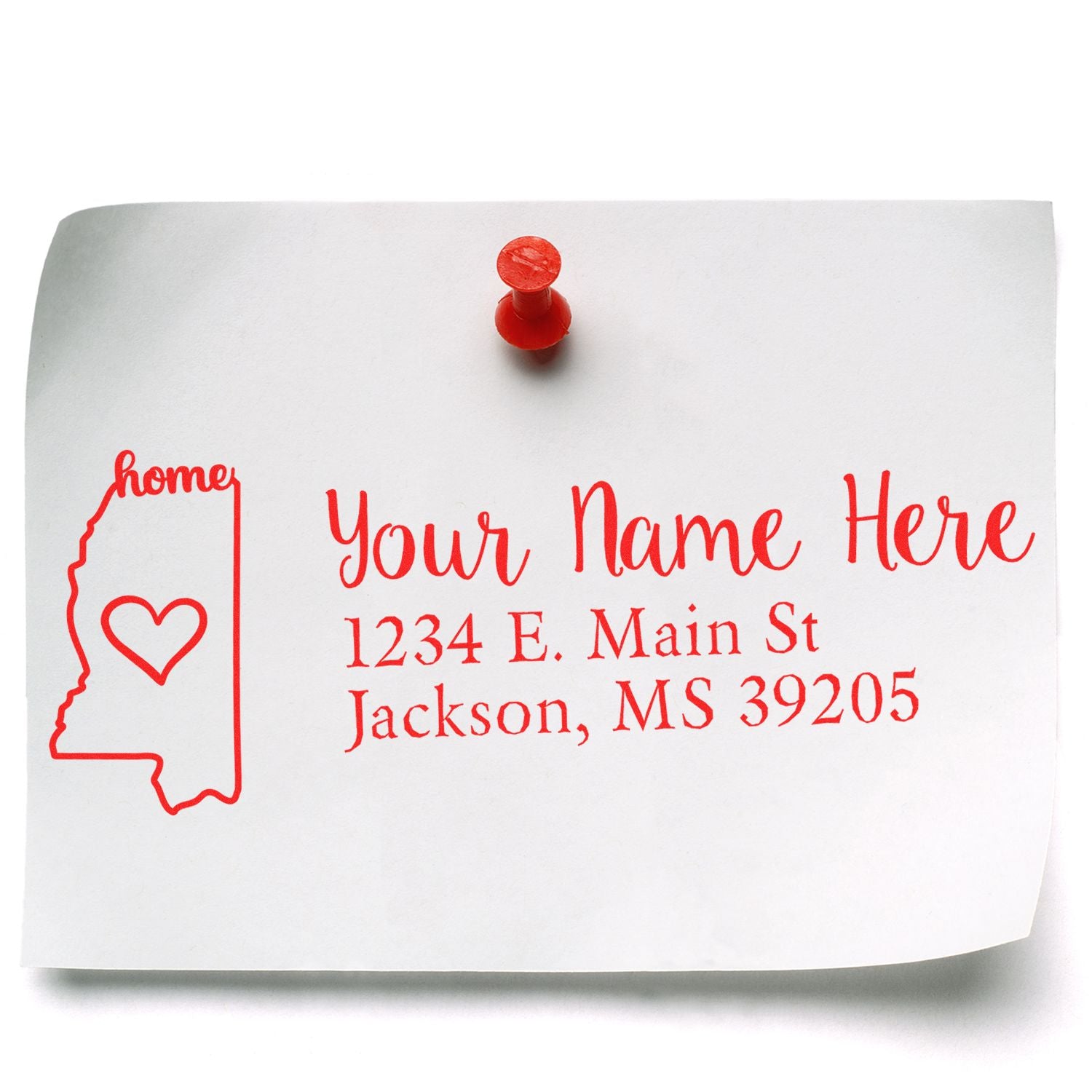 Image of a paper pinned to a board, featuring a red custom address design with Your Name Here and a heart inside the Mississippi outline. Showcases the Wood Handle Mississippi Custom Address Rubber Stamp.