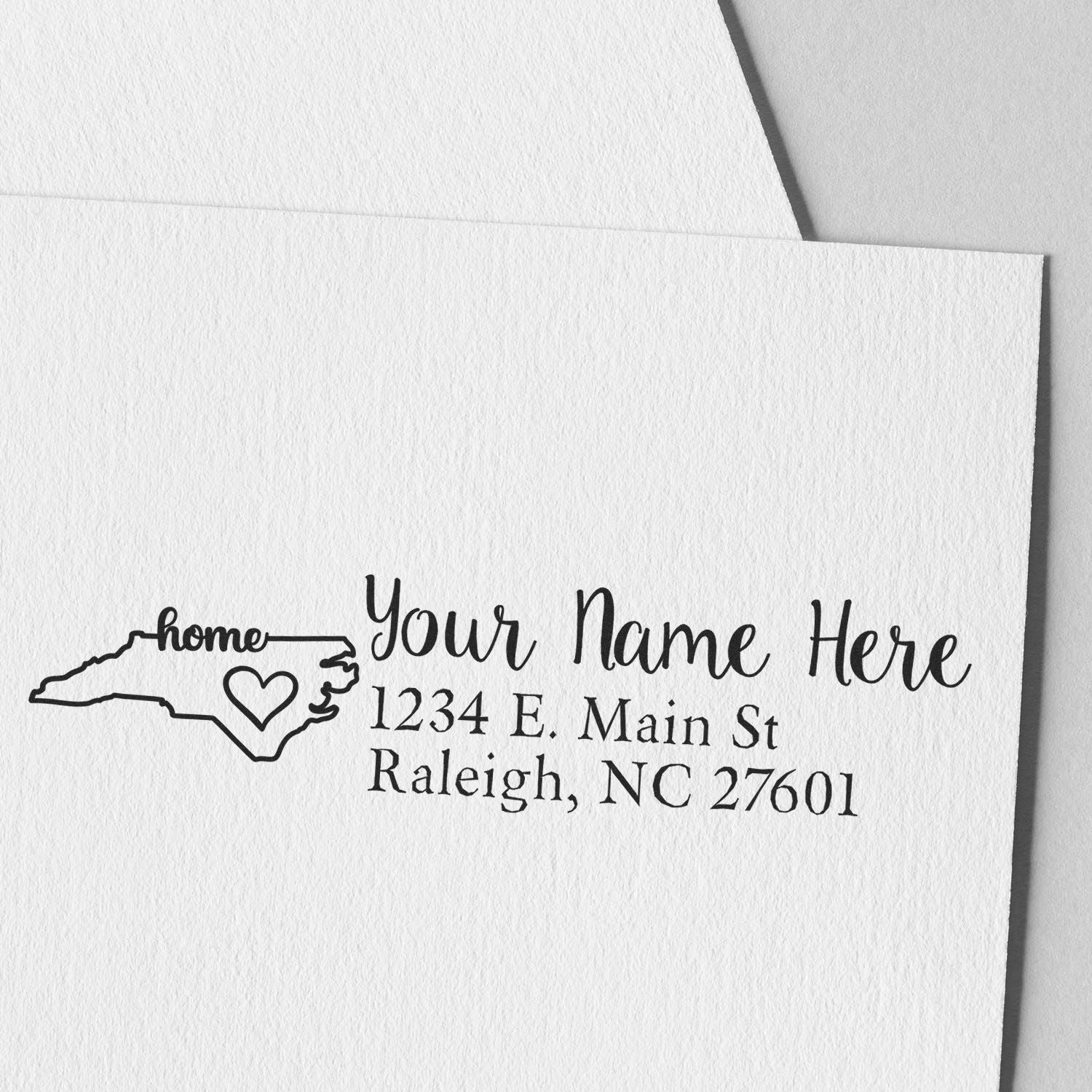 North Carolina Self-Inking State Love Address Stamp on white paper, featuring a heart design within the state outline and customizable address text.