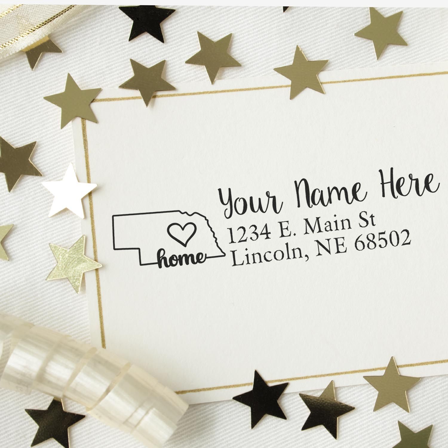 PSI Pre-Inked Personalized Nebraska State Love Address Stamp on a card with gold stars and ribbon, featuring a heart design and customizable address text.