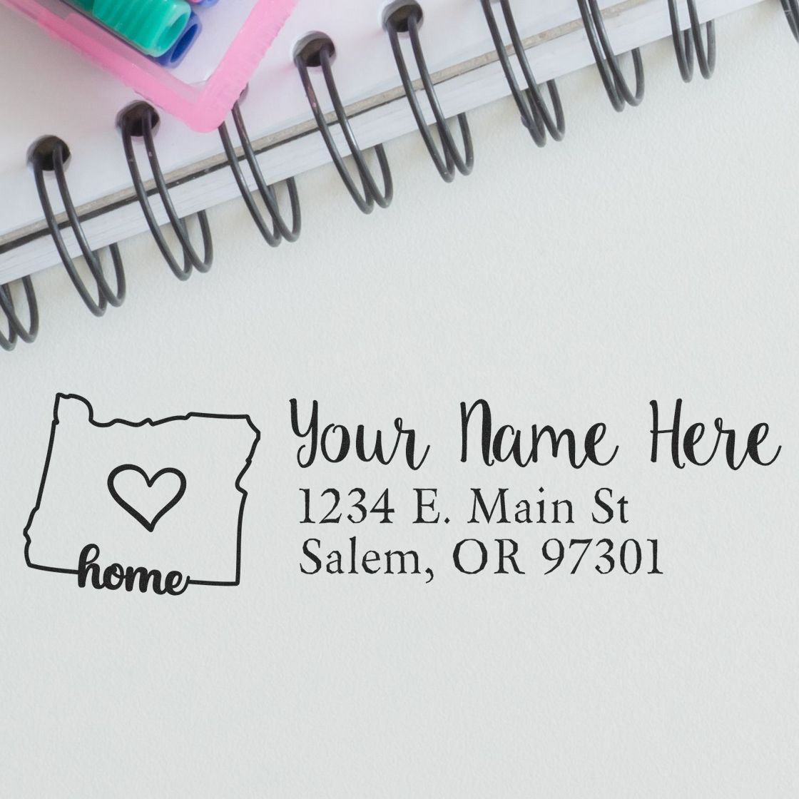 PSI Pre-Inked Personalized Oregon State Love Address Stamp on paper, featuring a heart inside Oregon's outline, with customizable name and address. Perfect for adding a personal touch to mail.