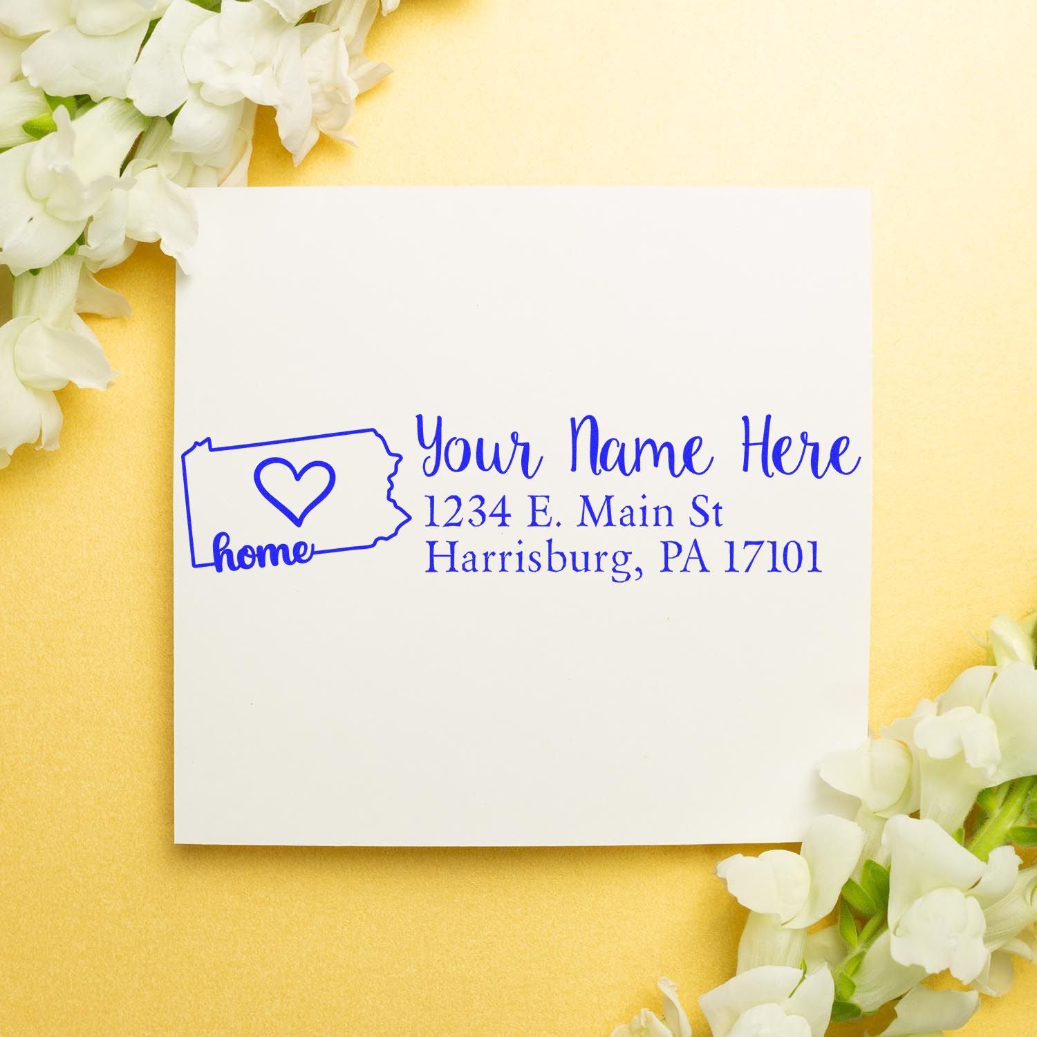 PSI Pre-Inked Personalized Pennsylvania State Love Address Stamp on white paper with blue ink, featuring a heart and home text, surrounded by white flowers on a gold background.