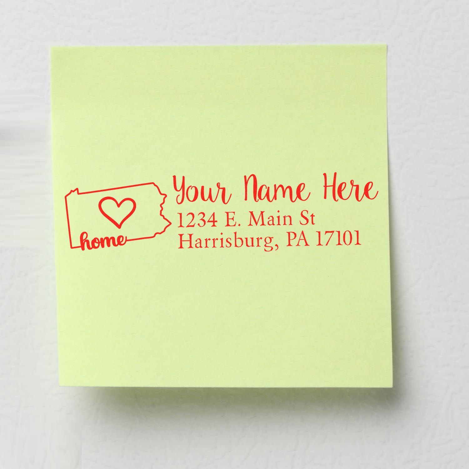 Pennsylvania Self-Inking State Love Address Stamp on a green sticky note, featuring a heart and the word 'home' with a sample address in red ink.