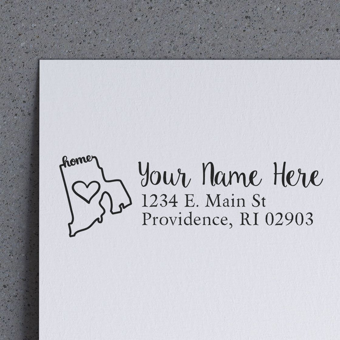 Wood Handle Rhode Island Custom Address Rubber Stamp on white paper, featuring a heart within the state outline and personalized address text.