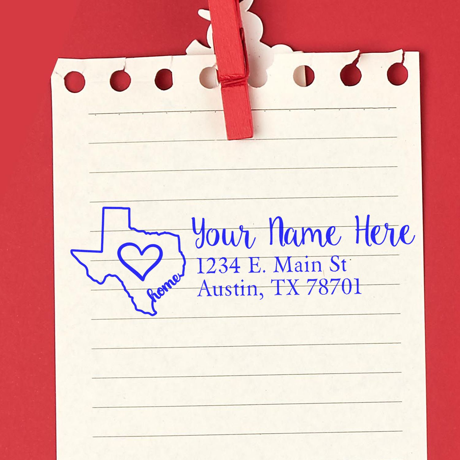 Texas Self-Inking State Love Address Stamp on a notepad with a red clip, featuring a heart inside the Texas outline and customizable address text in blue.