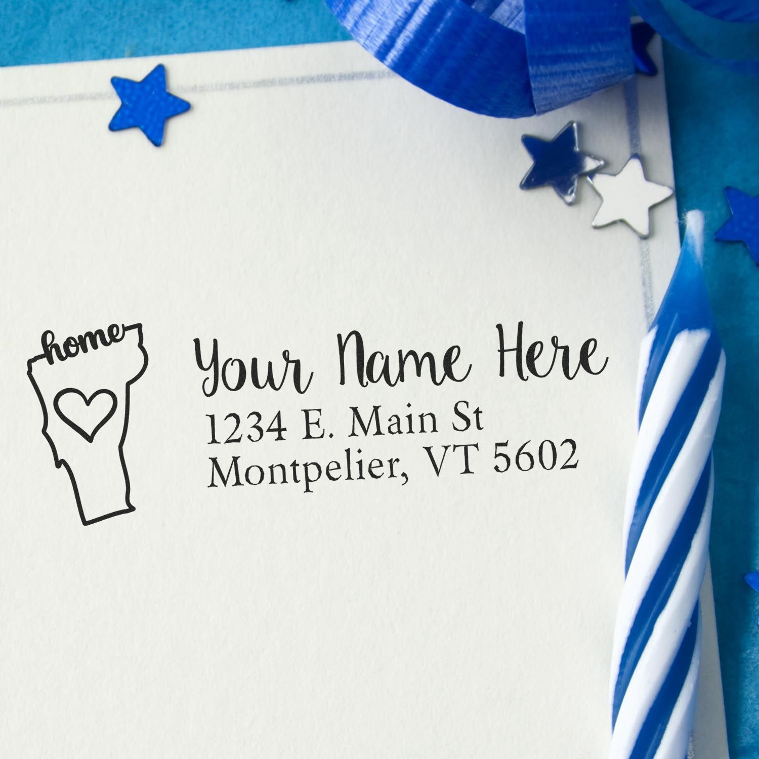 PSI Pre-Inked Personalized Vermont State Love Address Stamp on an envelope with blue stars and a striped candle, showcasing a Vermont outline with home text and a heart.