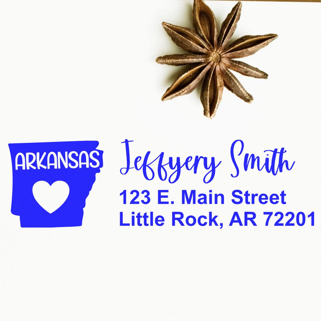 State Love of Arkansas Custom Address Stamp Self-Inking on white paper, featuring a blue Arkansas state outline with a heart, personalized with Jeffery Smith, 123 E. Main Street, Little Rock, AR 72201.