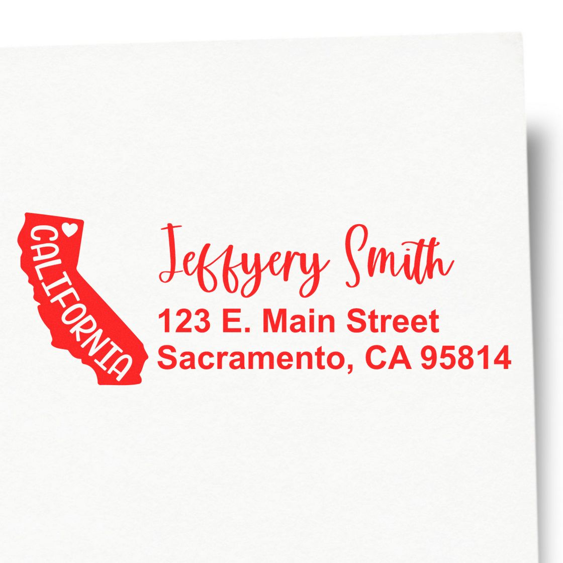 Slim California Custom Address Stamp for Envelopes featuring a red California outline with heart, personalized with Jeffery Smith, 123 E. Main Street, Sacramento, CA 95814 in red script.