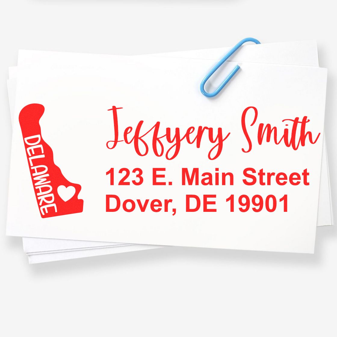 PSI Pre-Inked Delaware State Love Customized Address Stamp on white paper, featuring red text with a Delaware state outline and heart.