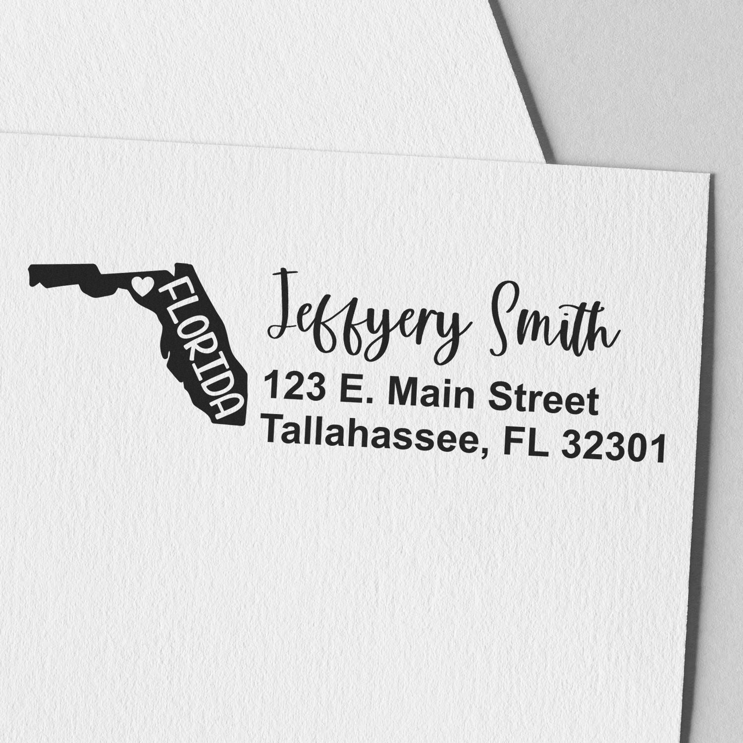 Slim Florida Custom Address Stamp for Envelopes featuring a Florida state outline and personalized address in elegant script on white paper.