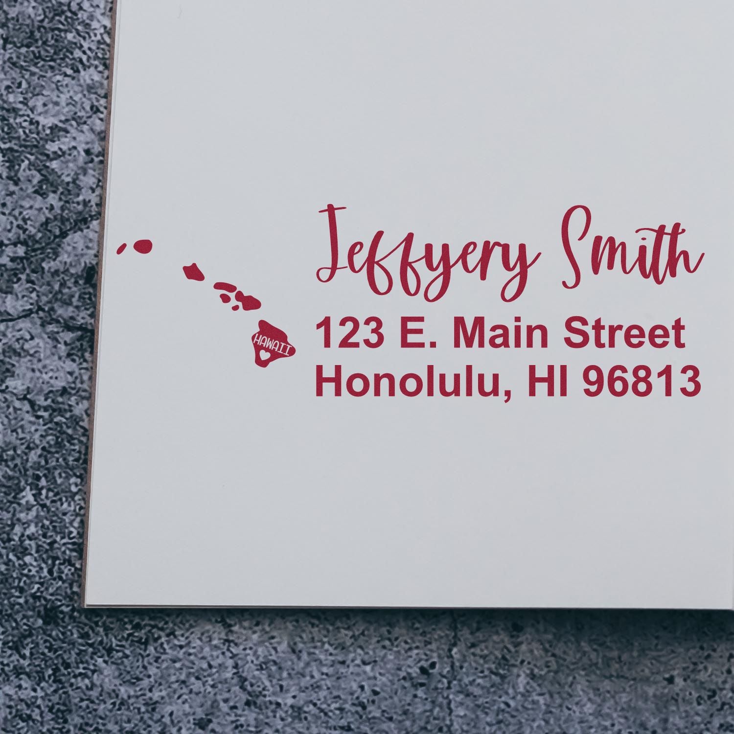 Hawaii State Love Personalized Address Stamp featuring red text with a heart and map design, displaying Jeffery Smith, 123 E. Main Street, Honolulu, HI 96813 on a textured gray background.