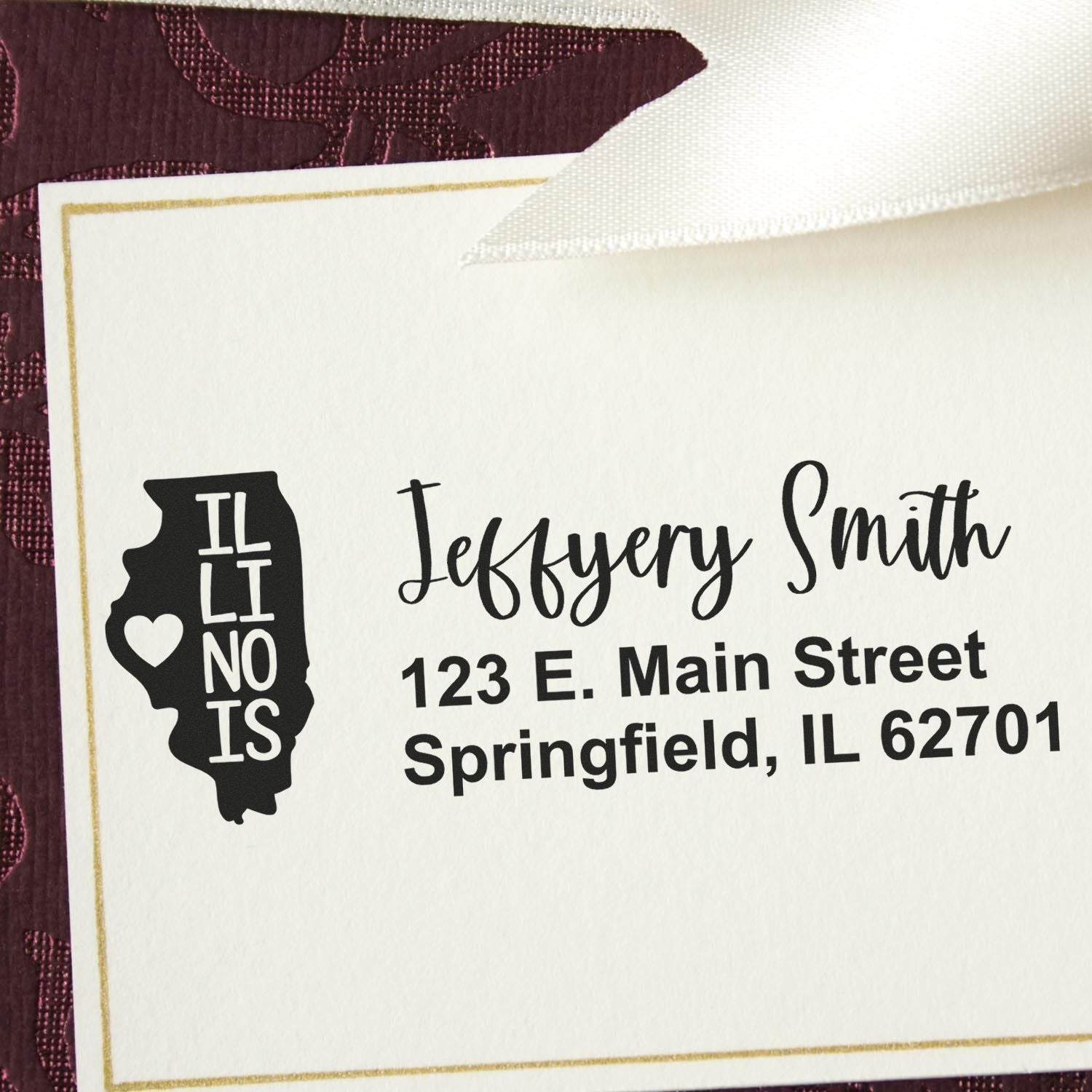 Illinois State Love Personalized Address Stamp on a card with a heart design, featuring the name Jeffery Smith and Springfield, IL address, set against a burgundy patterned background.