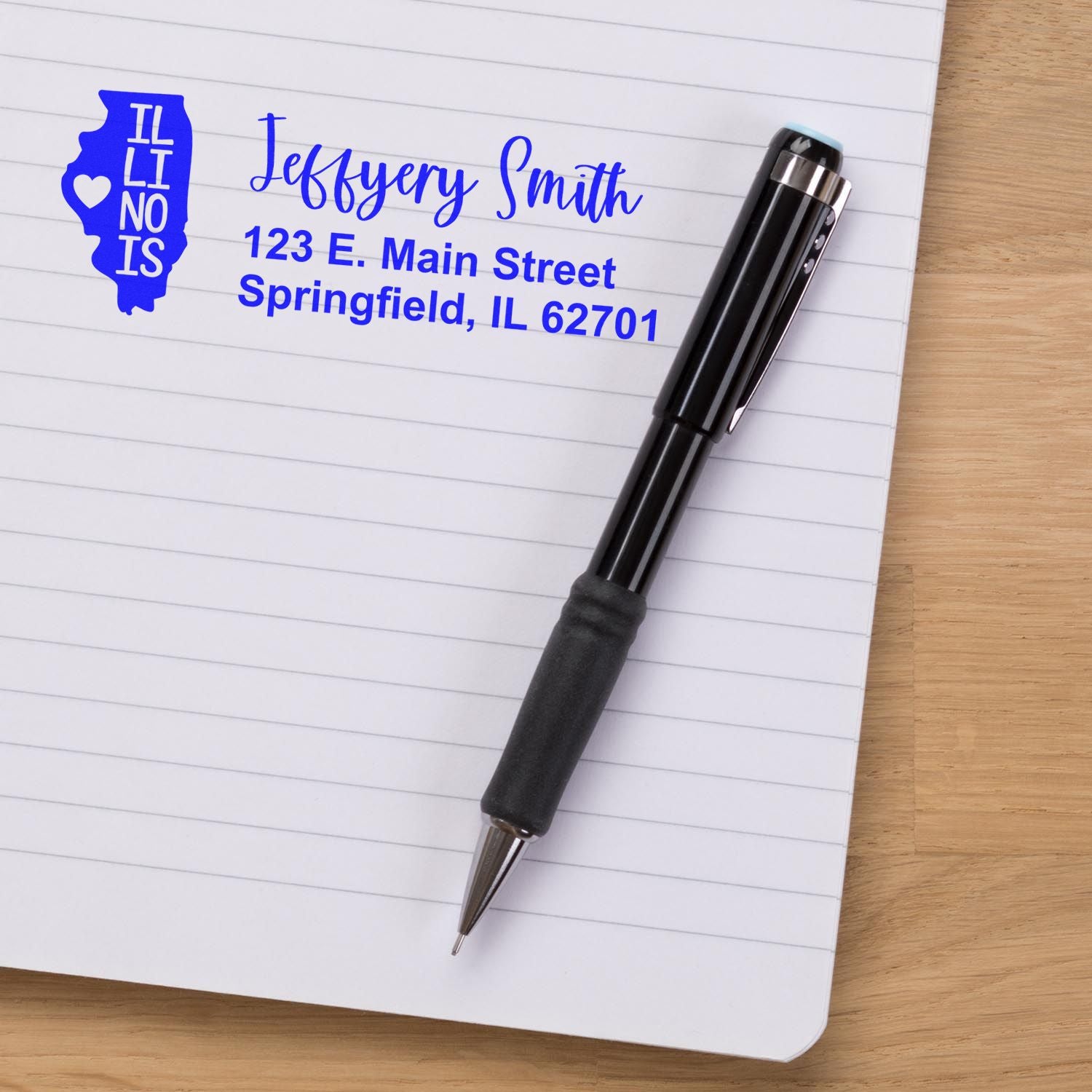 Illinois State Love Personalized Address Stamp on notepad with pen, featuring a blue state outline and custom address for Jeffery Smith, 123 E. Main Street, Springfield, IL 62701.