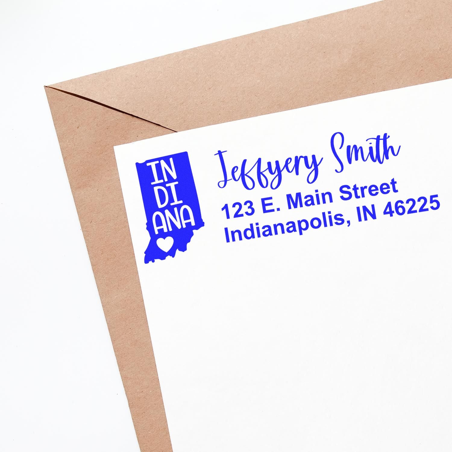 Envelope with a blue State Love of Indiana Custom Address Stamp Self-Inking featuring Indiana's outline and heart, personalized with a name and address in a stylish font.